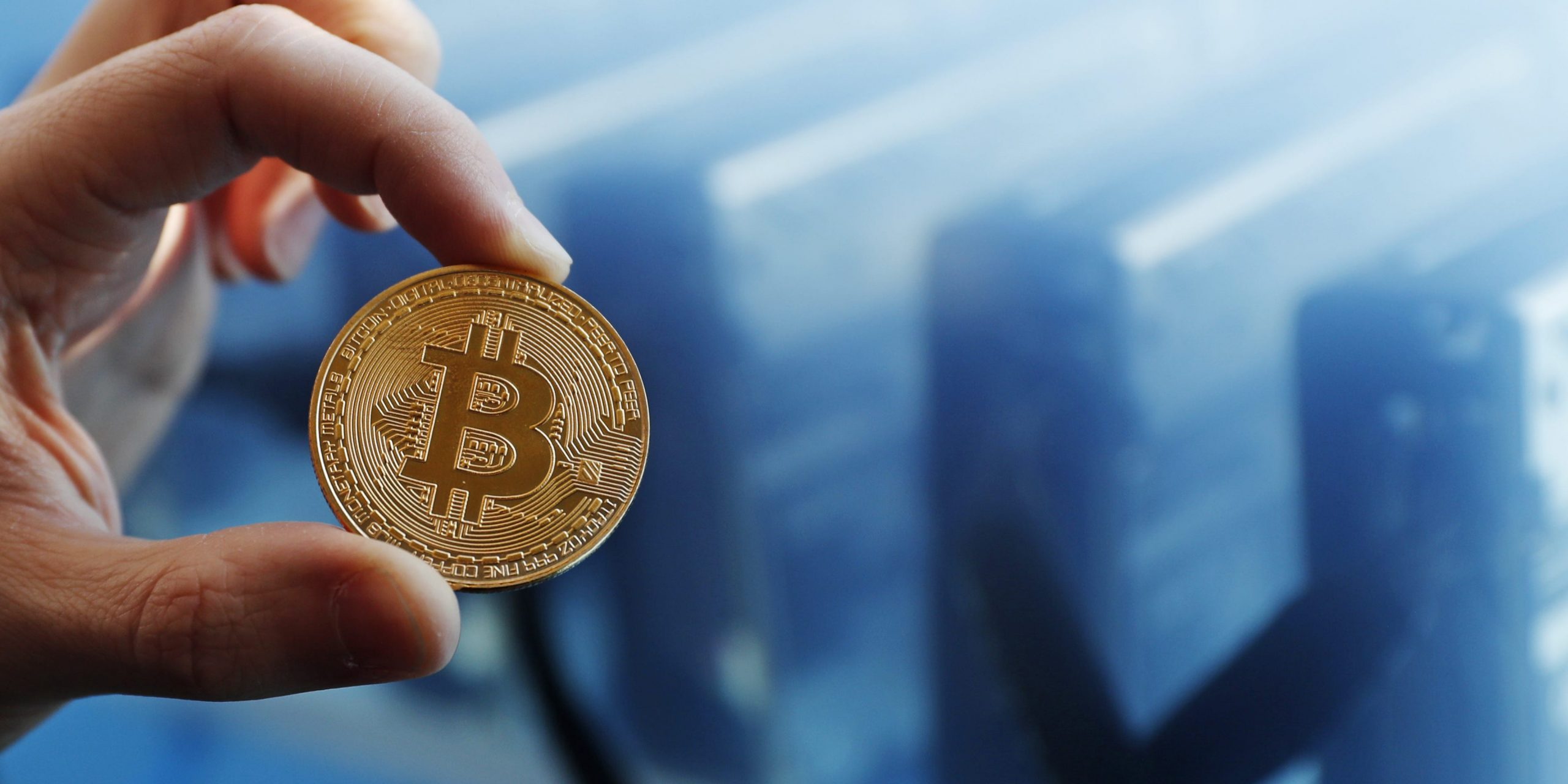 Bitcoin logo mining hand person