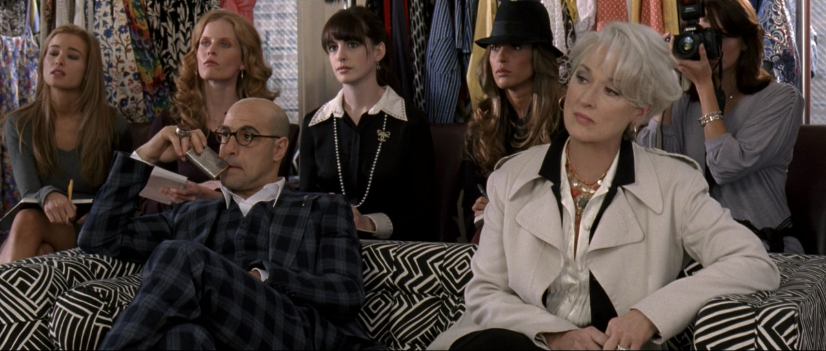Stanley Tucci, Anne Hathaway, and Meryl Streep sitting during a scene in "The Devil Wears Prada."
