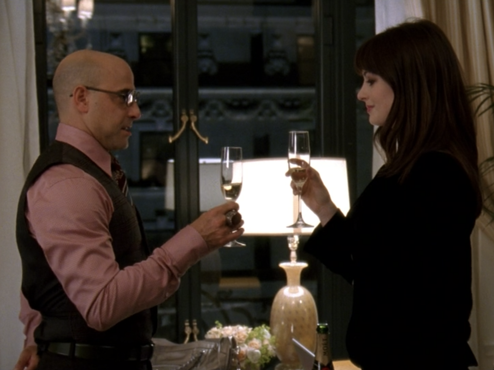 Stanley Tucci and Anne Hathaway toasting in "The Devil Wears Prada."