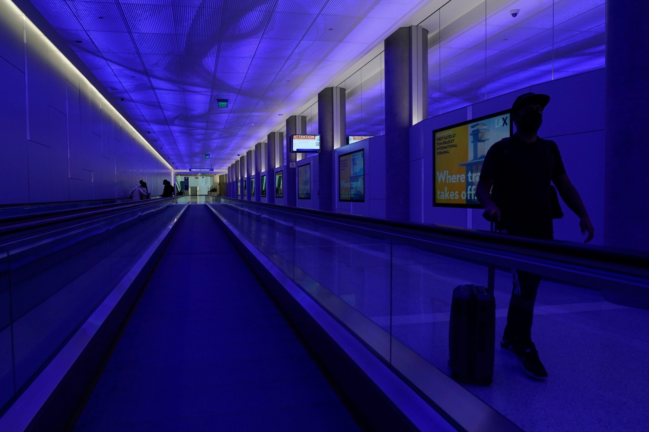 Traveler with suitcase in Los Angeles International Airport.