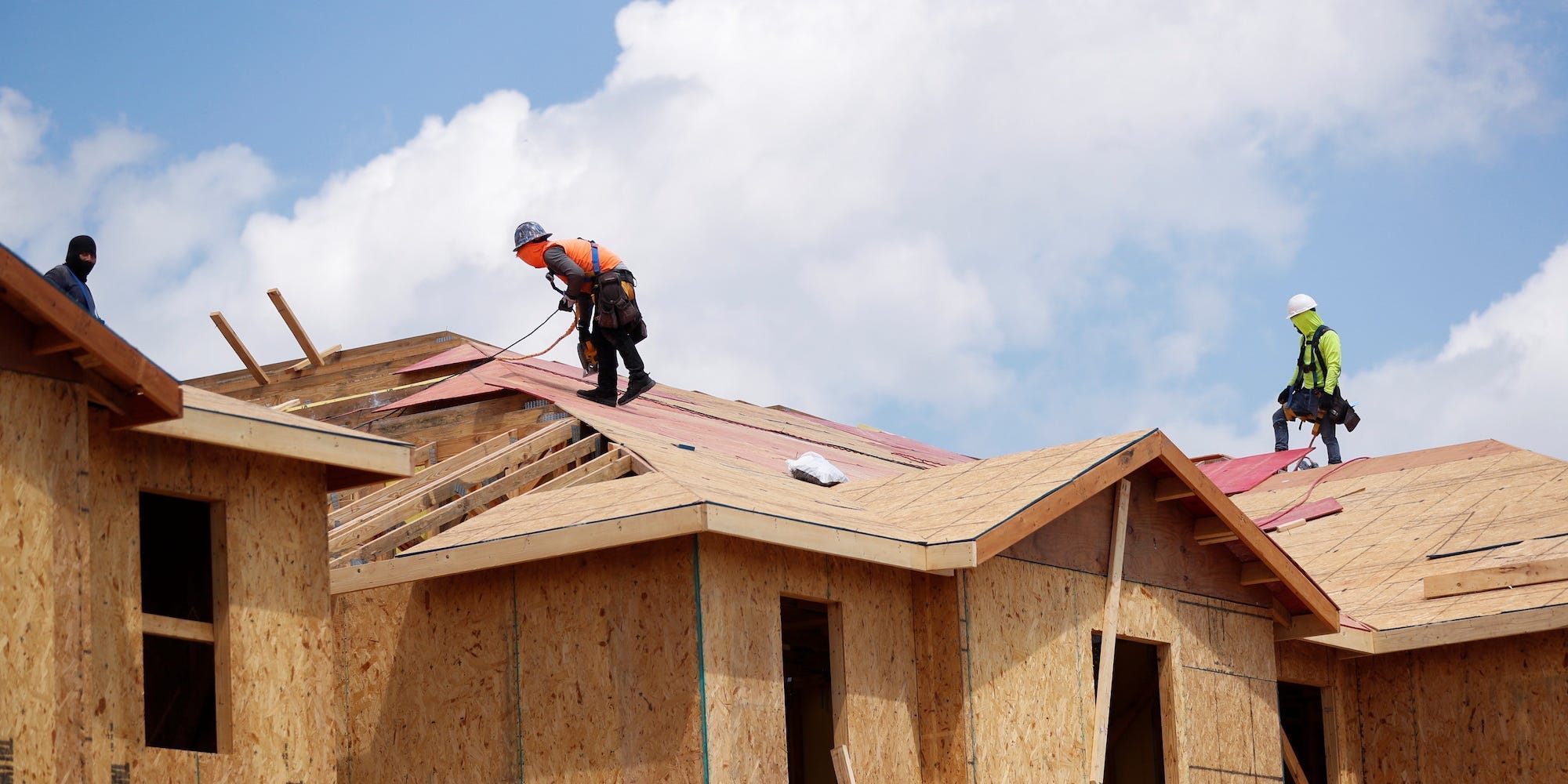 Carpenters work on building new townhomes