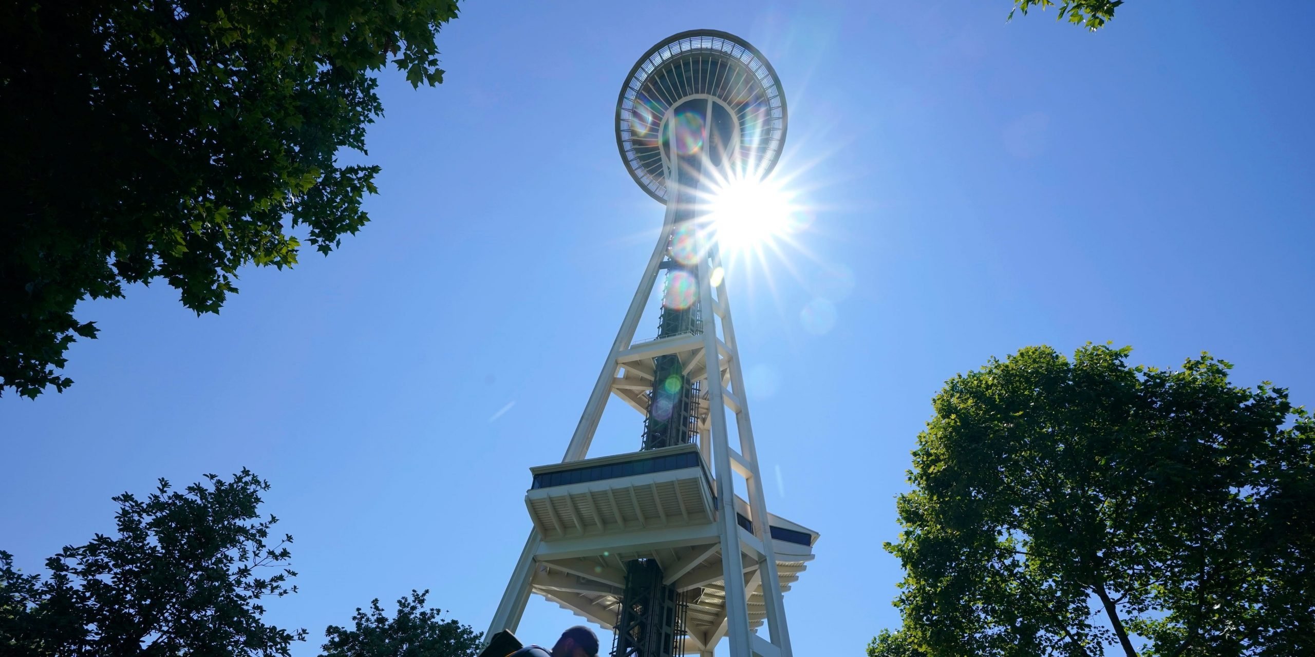 The Space Needle with the sun shining behind it.