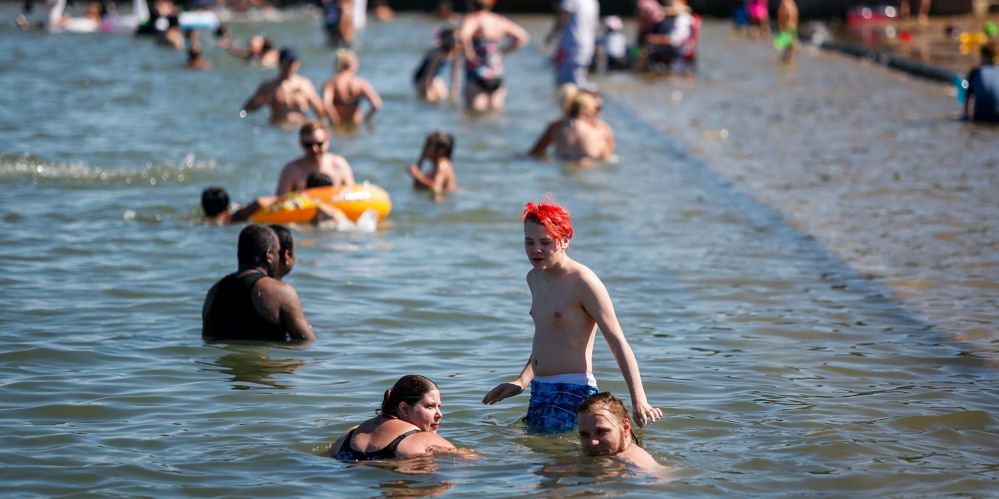 People in the water in Chestermere, Alta., Canada, on June 29, 2021.