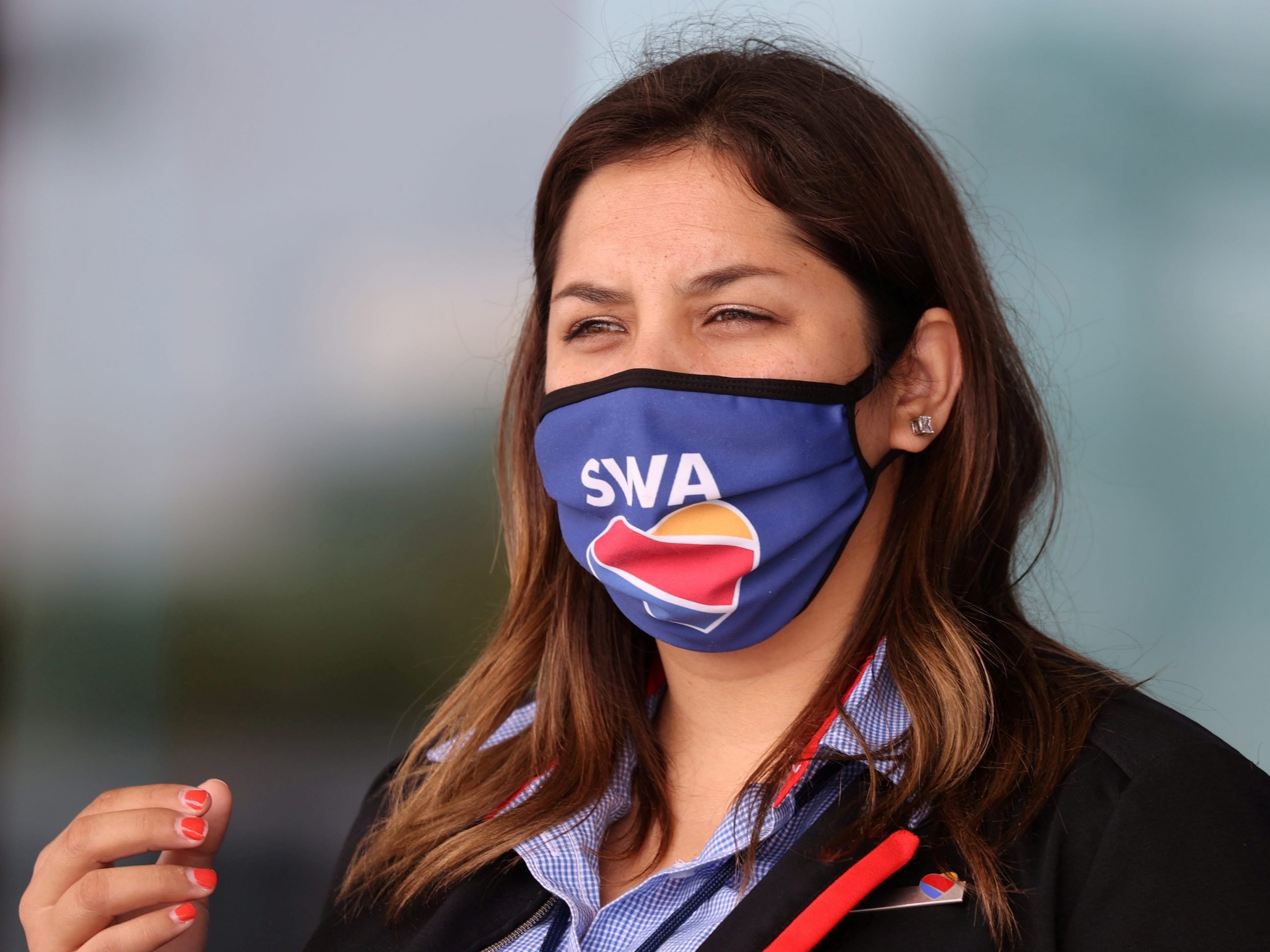 A gate agent wears a Southwest Airlines mask