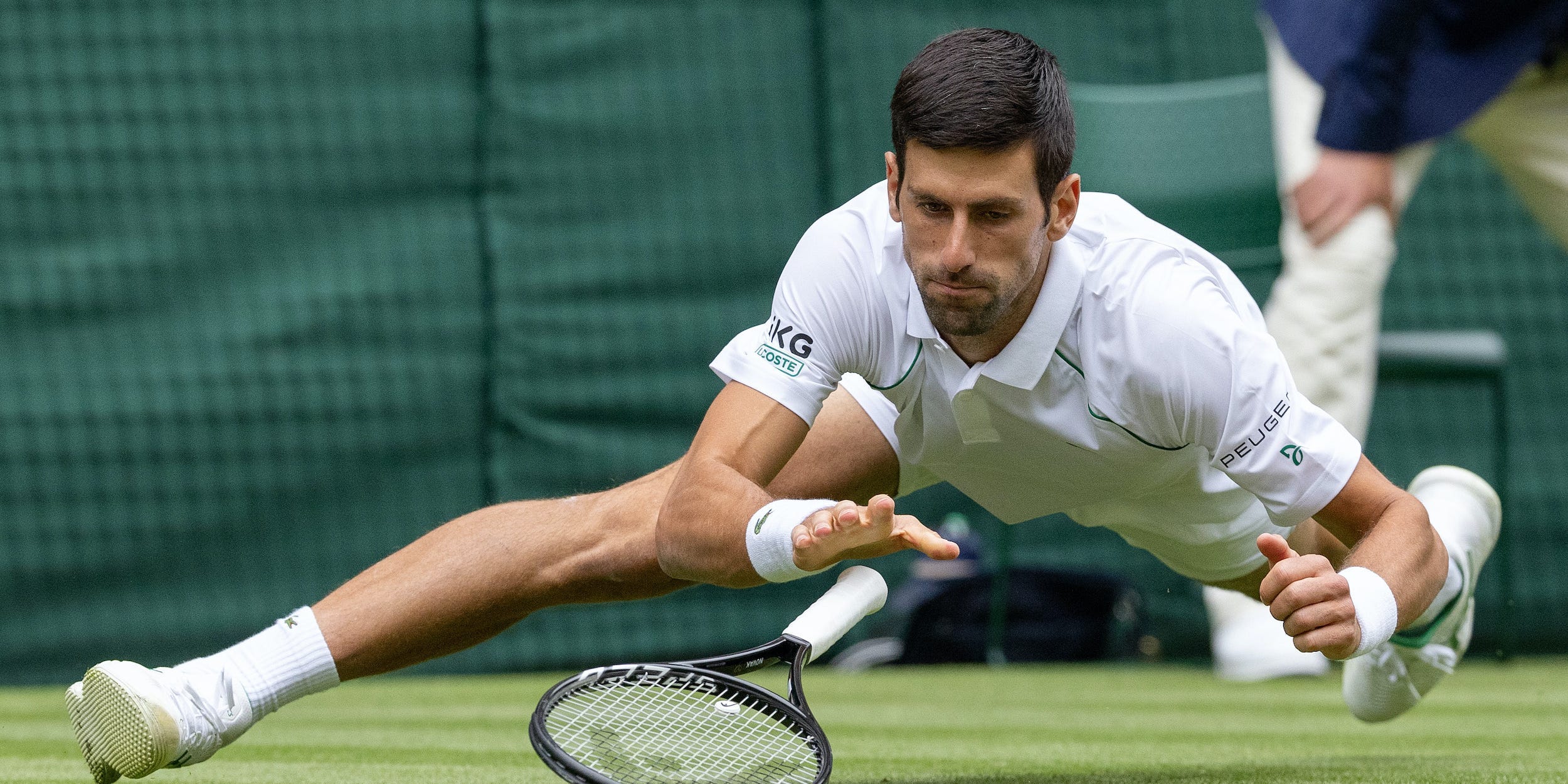 Novak Djokovic slips during 2nd round match at Wimbledon 2021
