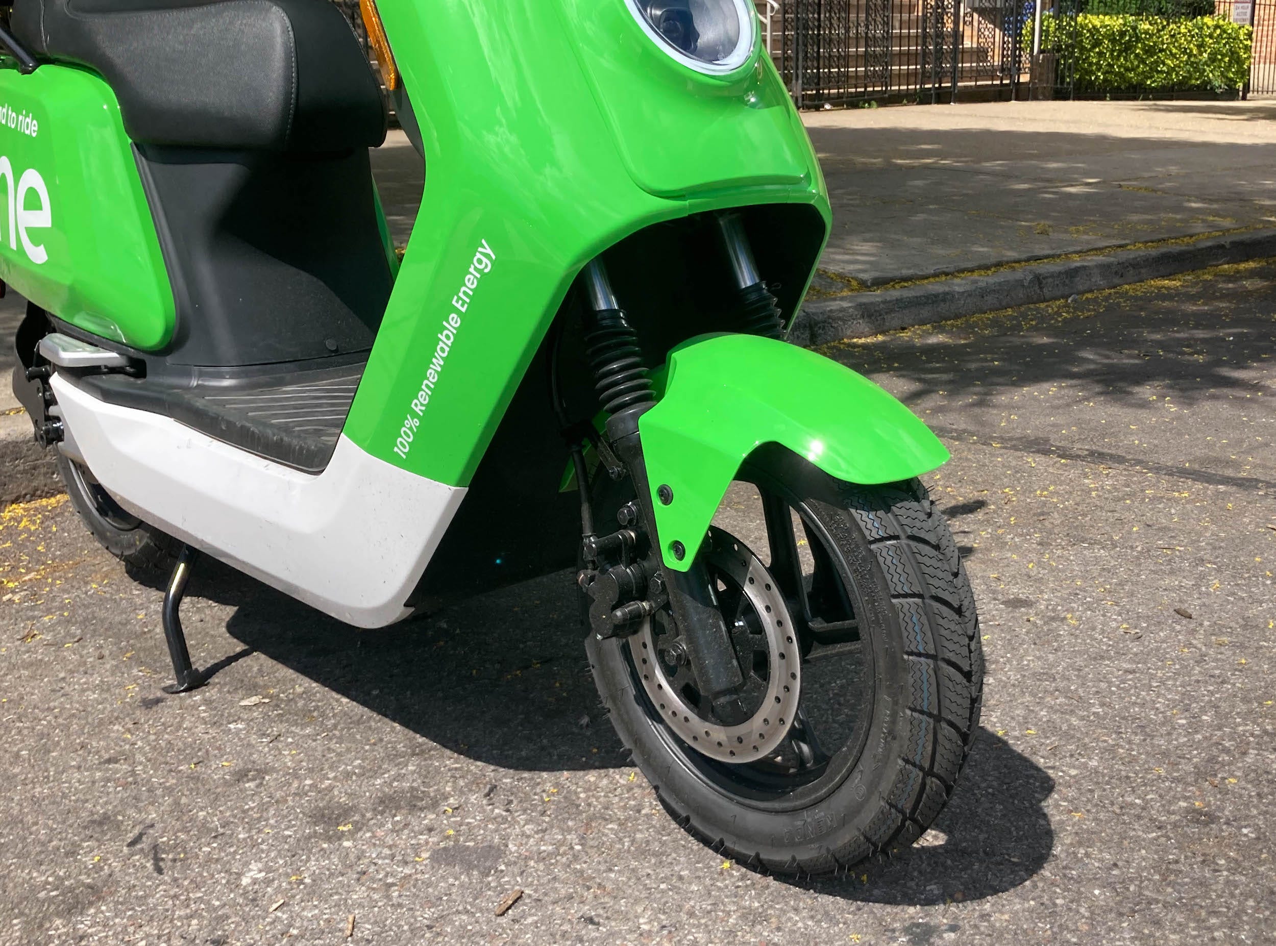 A bright green electric moped from the micromobility company Lime.