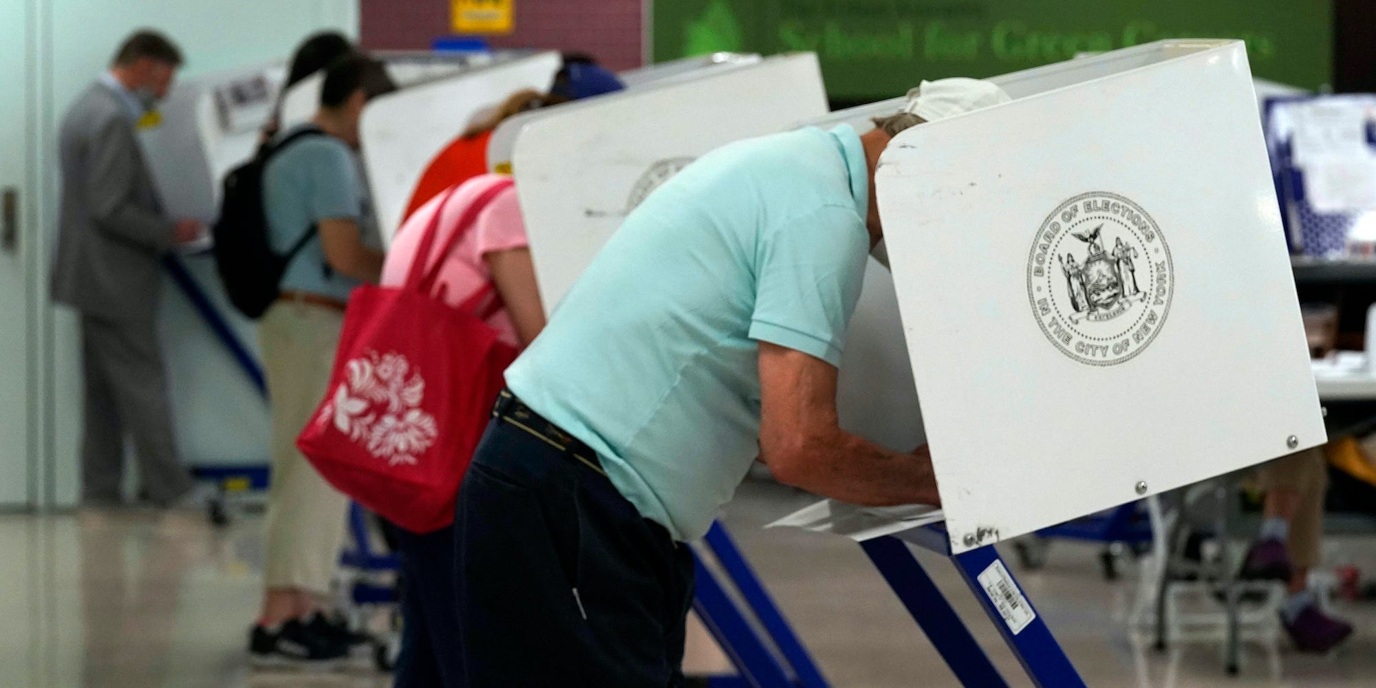 Voters mark their ballots at Frank McCourt High School, in New York, Tuesday, June 22, 2021