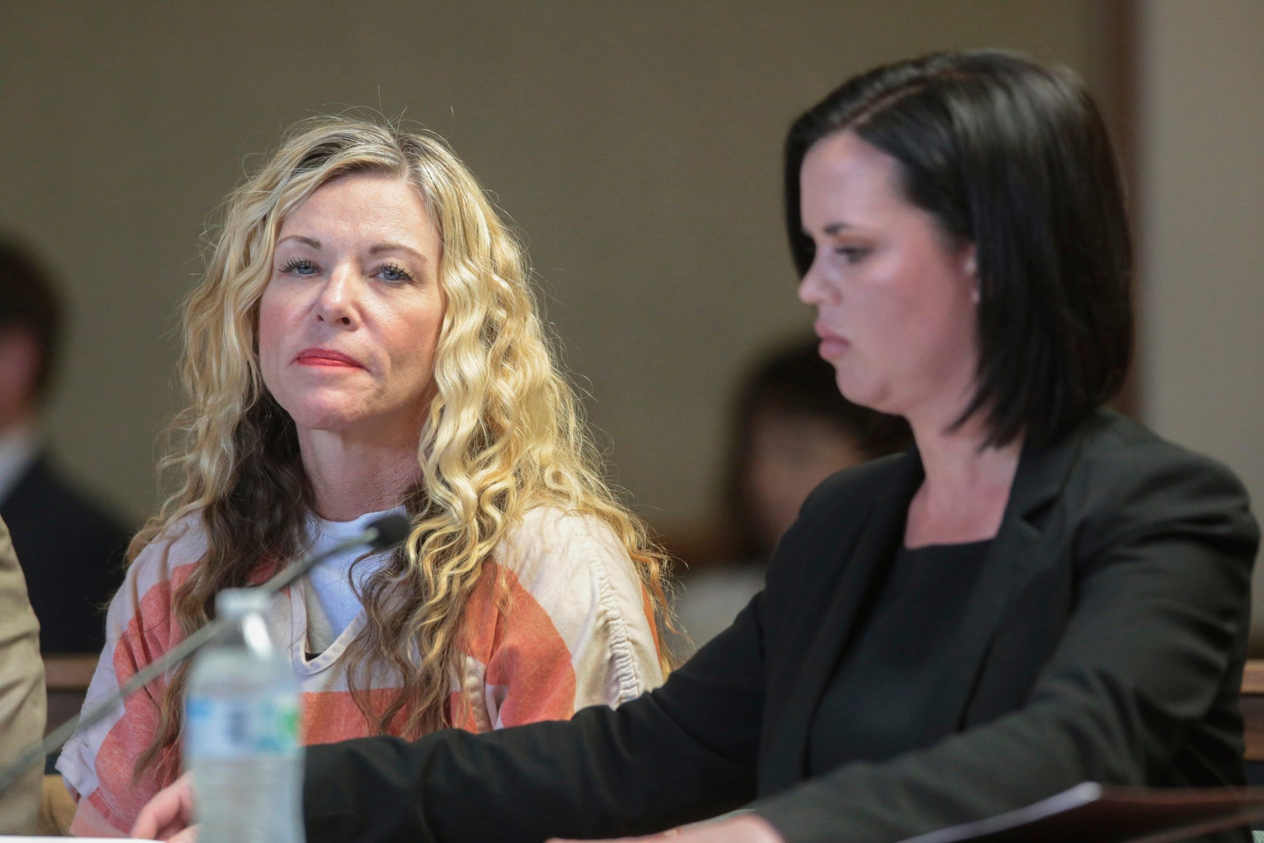 FILE - This March 6, 2020, file photo shows Lori Vallow, left, glancing at the camera next to her defense attorney, Edwina Elcox, during a hearing in Rexburg, Idaho. An autopsy report released Friday, May 8, 2020, has revealed that a pulmonary blood clot killed the brother of Vallow, who is being detained on charges related to the disappearance of her two children. (John Roark/The Idaho Post-Register via AP, Pool, File)