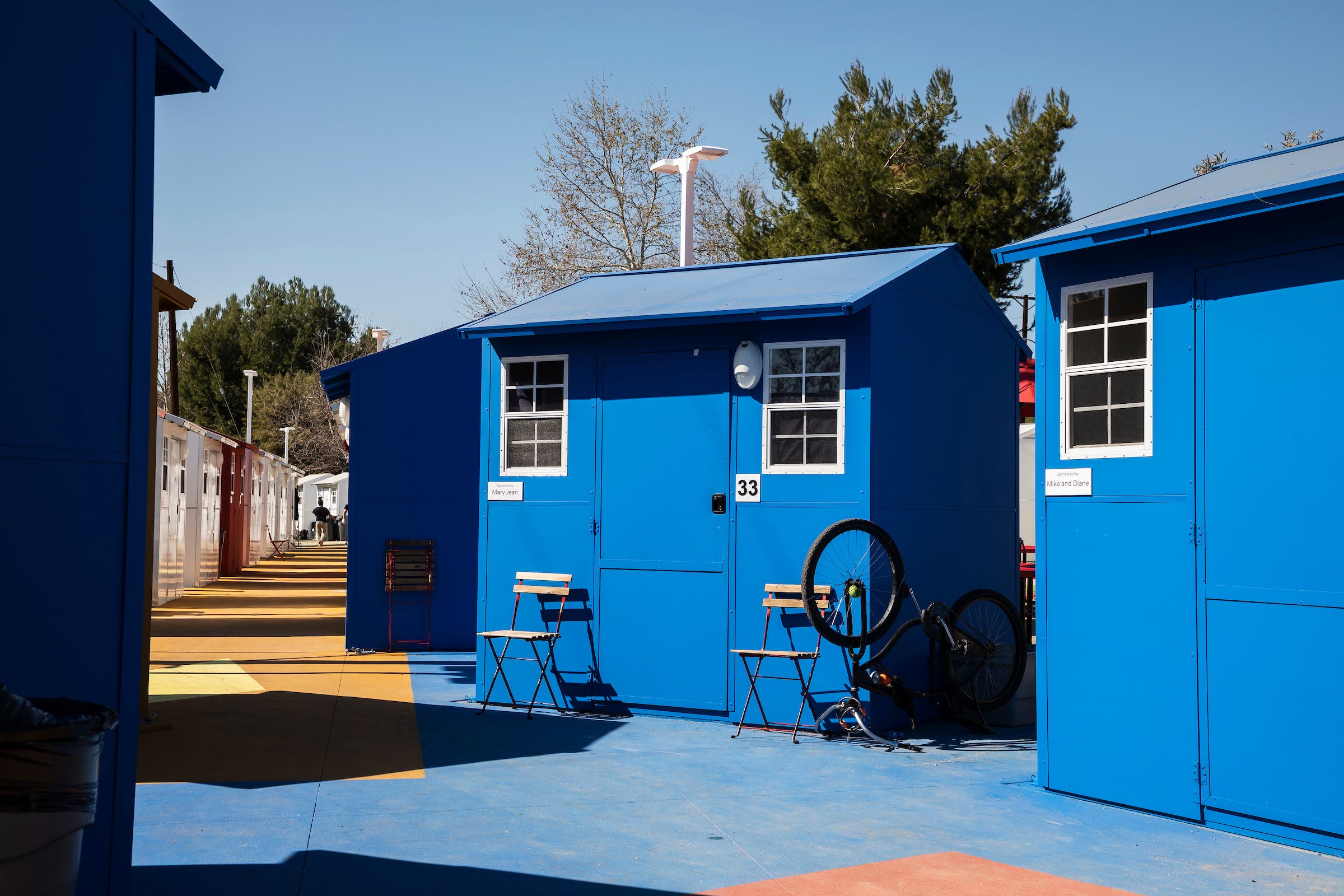 Two of the houses, painted blue.