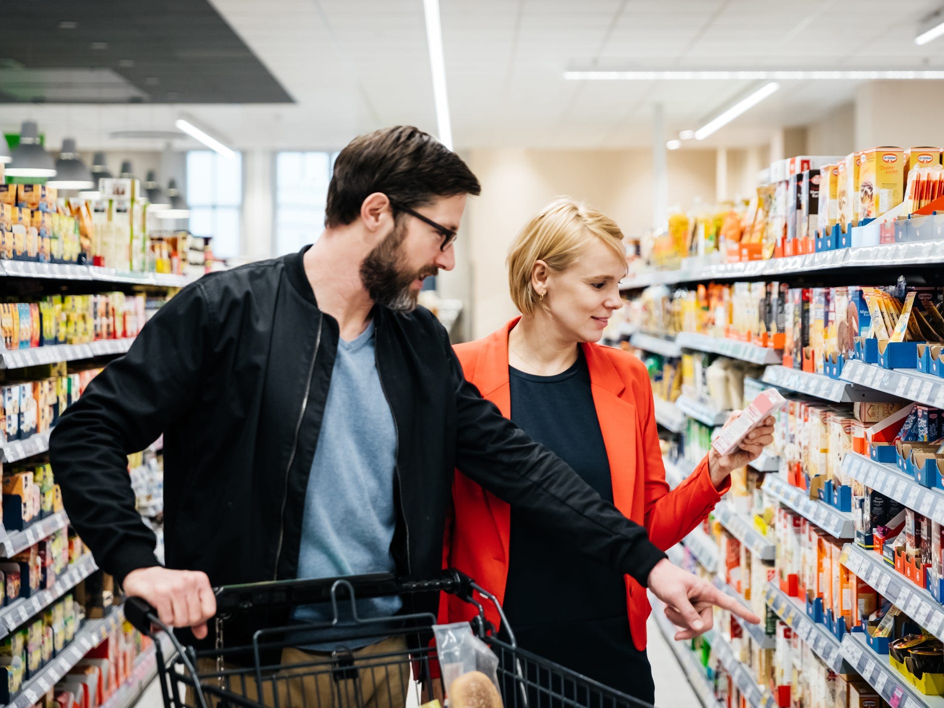 reading food labels grocery shopping couple husband wife