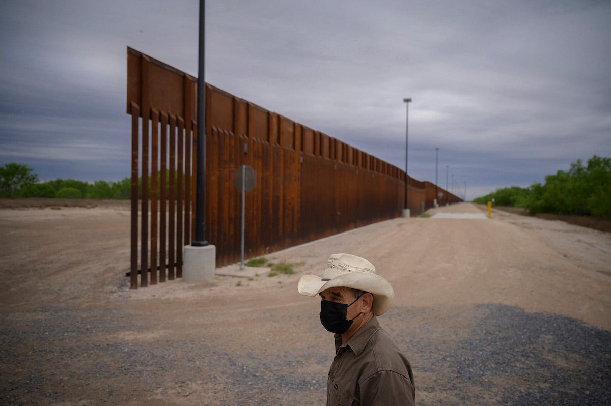 In a photo taken on March 28, 2021, ranch owner Tony Sandoval (67) stands before a portion of the unfinished border wall that former US president Donald Trump tried to build, near the southern Texas border city of Roma