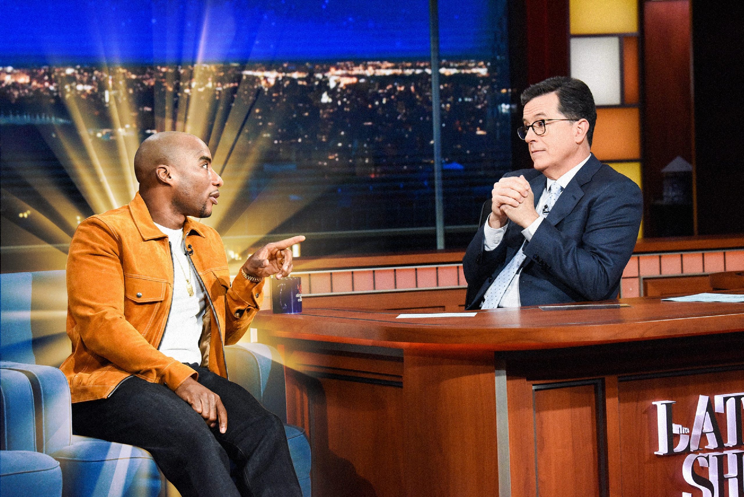Charlamagne Tha God with a golden light radiation from behind him talking to Stephen Colbert, host of The Late Show..