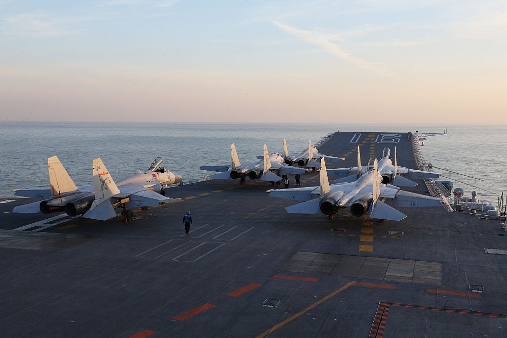 Chinese J-15 fighter jets waiting on the deck of the Liaoning aircraft carrier