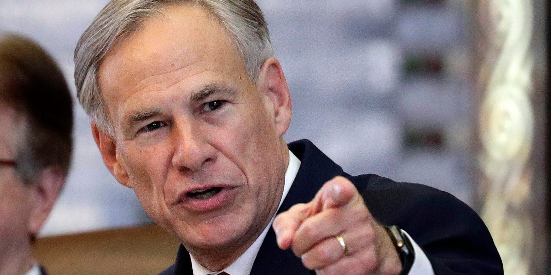 Texas Governor Greg Abbot points at the camera with a stern expression.