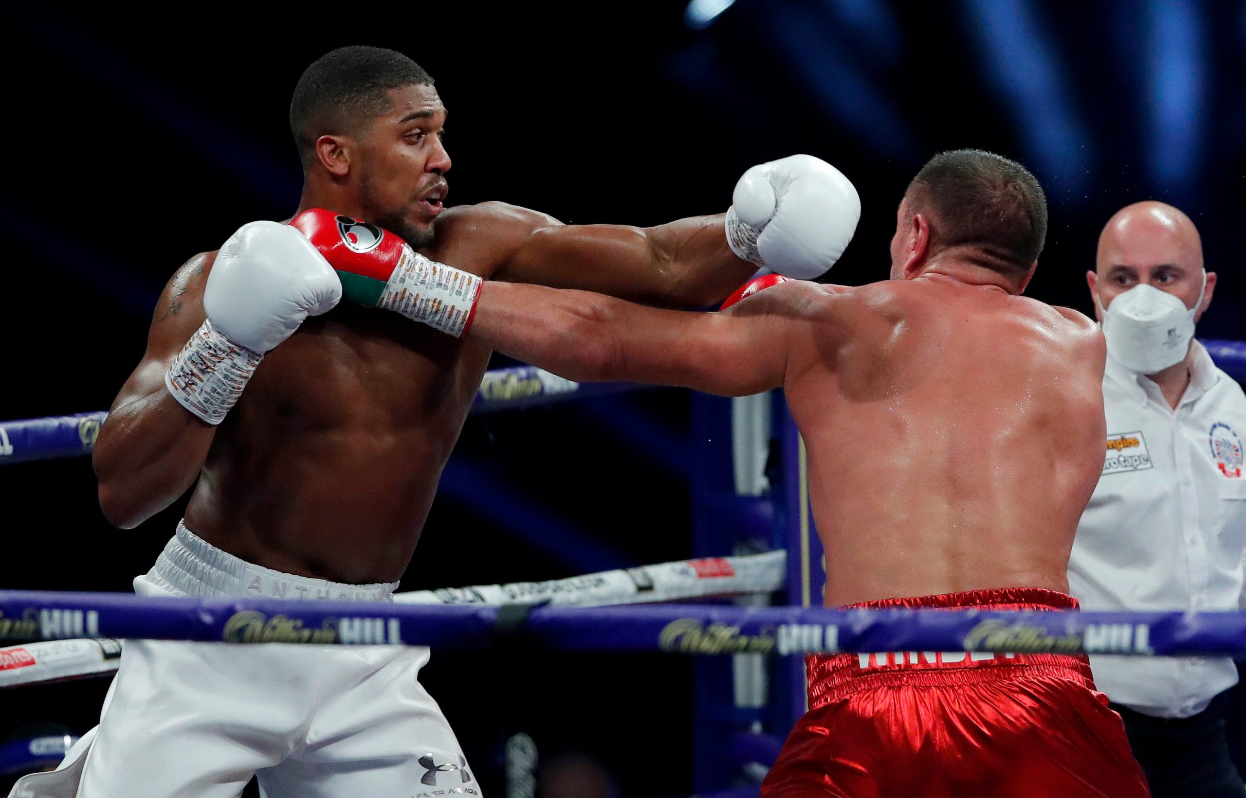 Anthony Joshua knocking out an opponent in a fight.