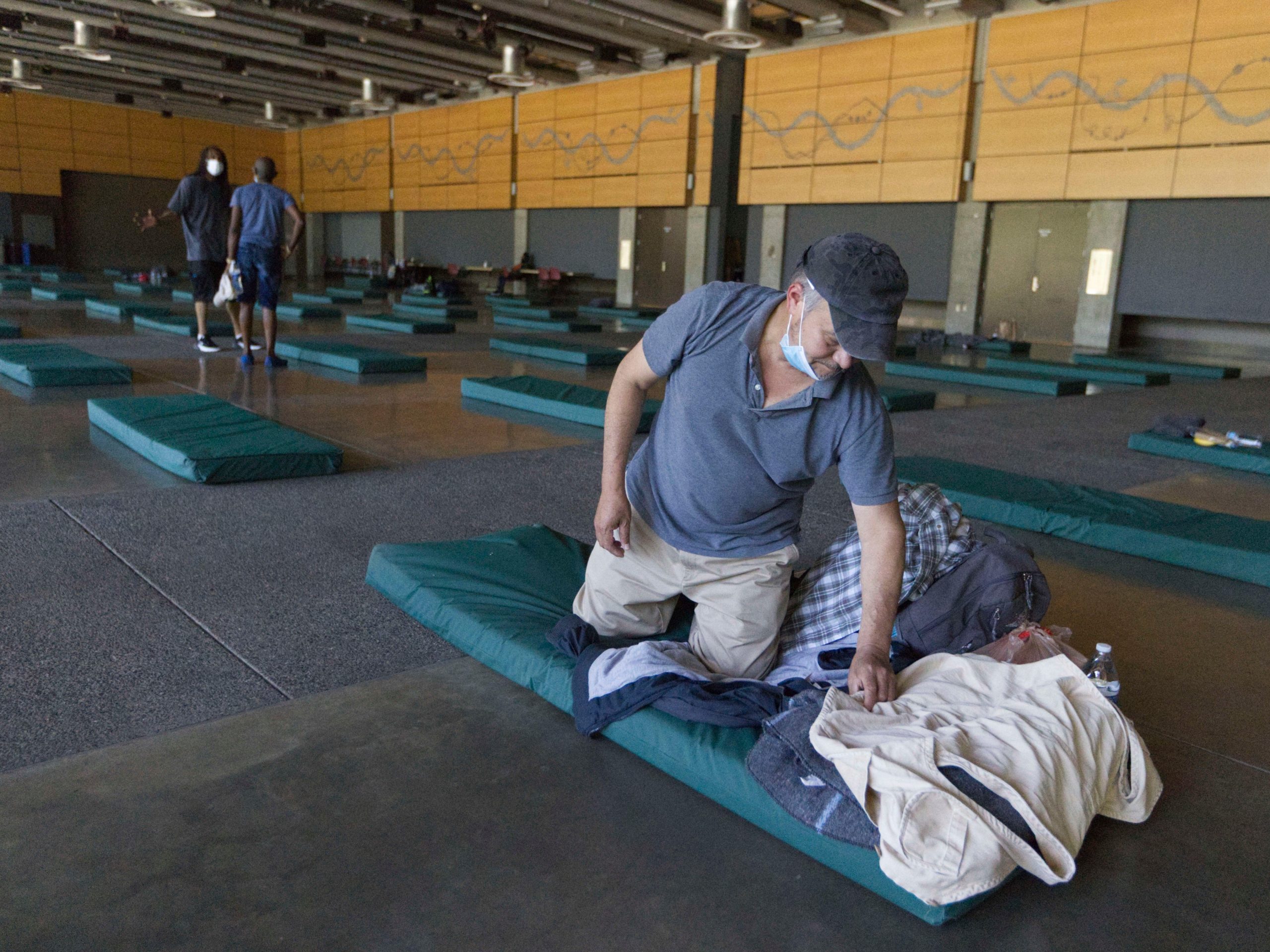 Man sets up bed in cooling shelter in seattle