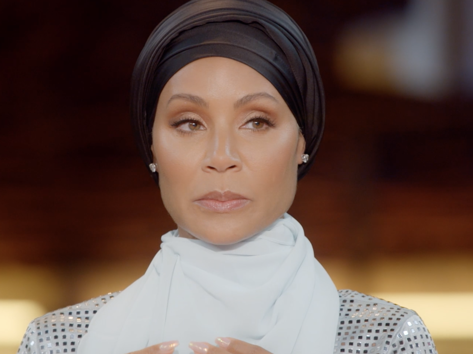 Jada Pinkett Smith sitting at a table on "Red Table Talk."