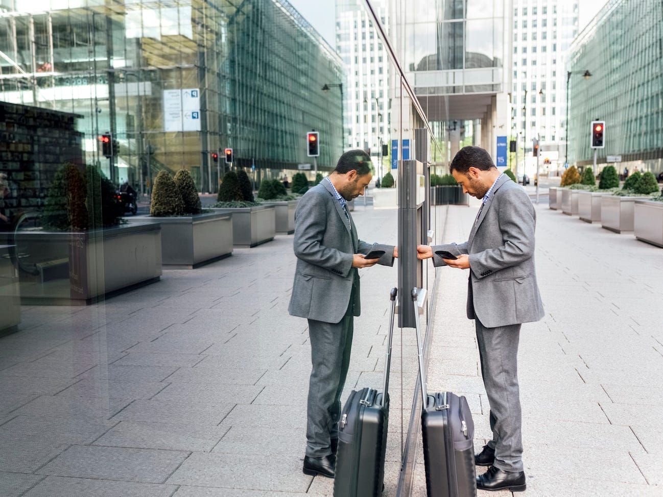 A man uses an ATM outdoors.