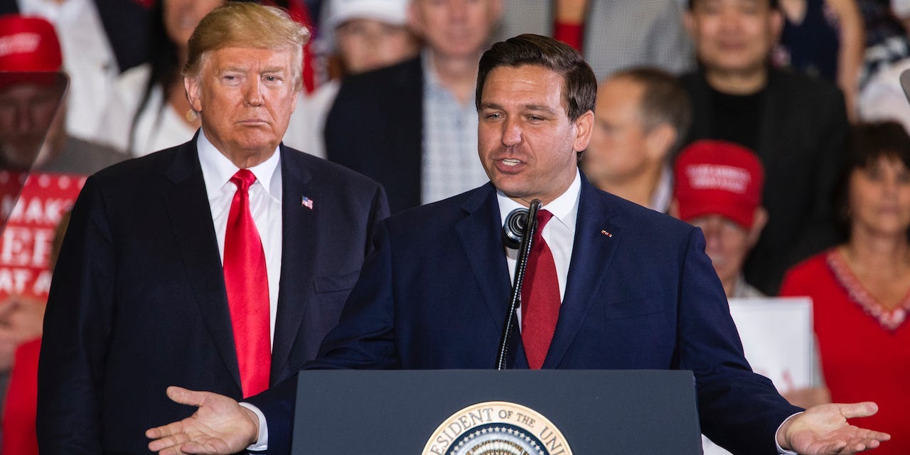 Florida Republican gubernatorial candidate Ron DeSantis speaks with U.S. President Donald Trump at a campaign rally at the Pensacola International Airport on November 3, 2018 in Pensacola, Florida.