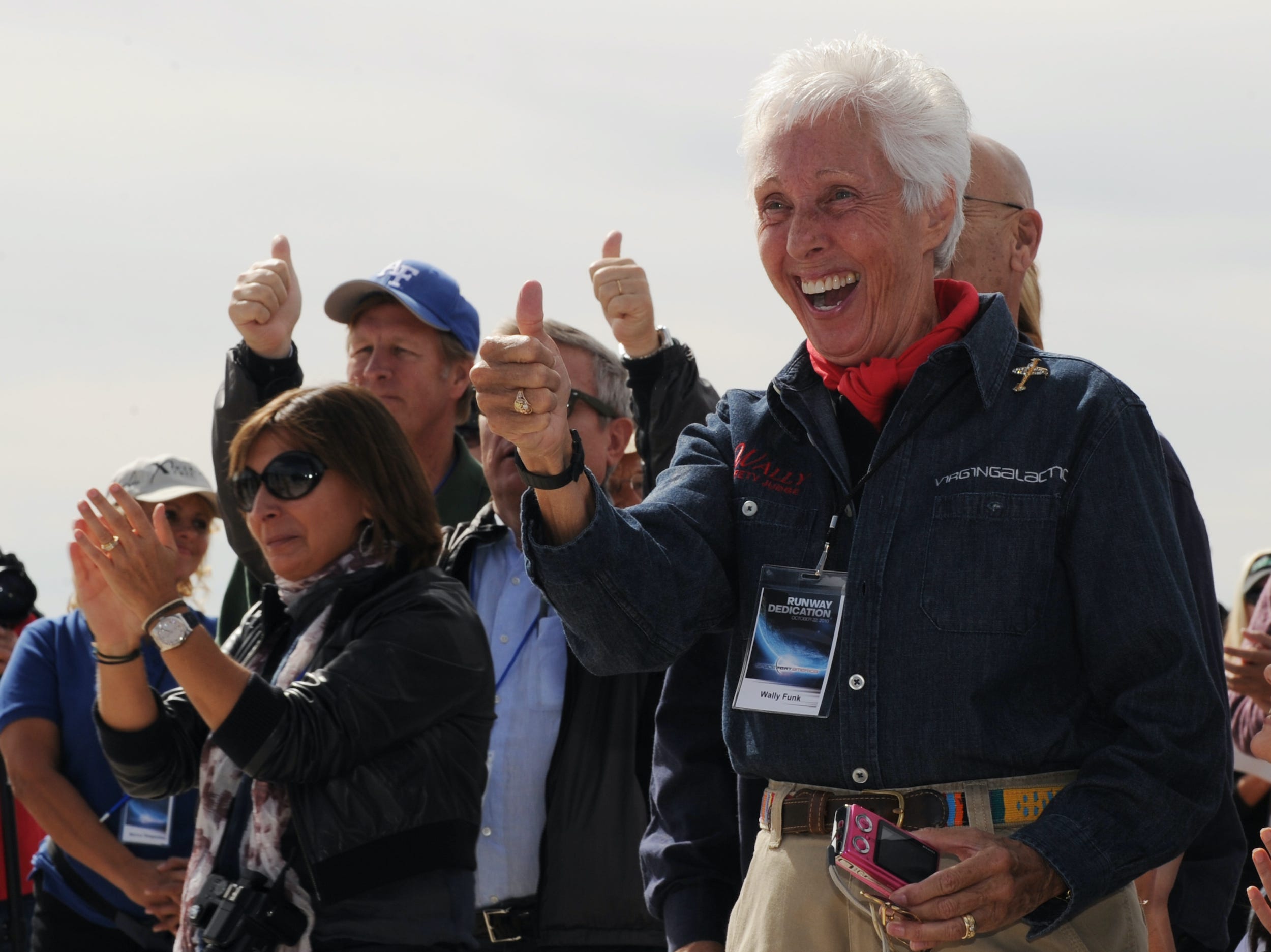 Aviator Wally Funk gives a thumbs up surrounded by other hopeful space tourists