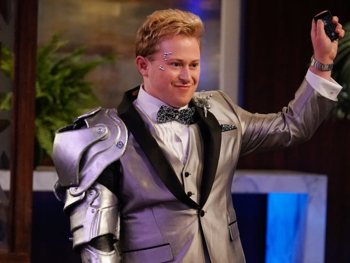 Reed Alexander wearing a silver suit and holding a black remote on episode five of the "iCarly" revival.