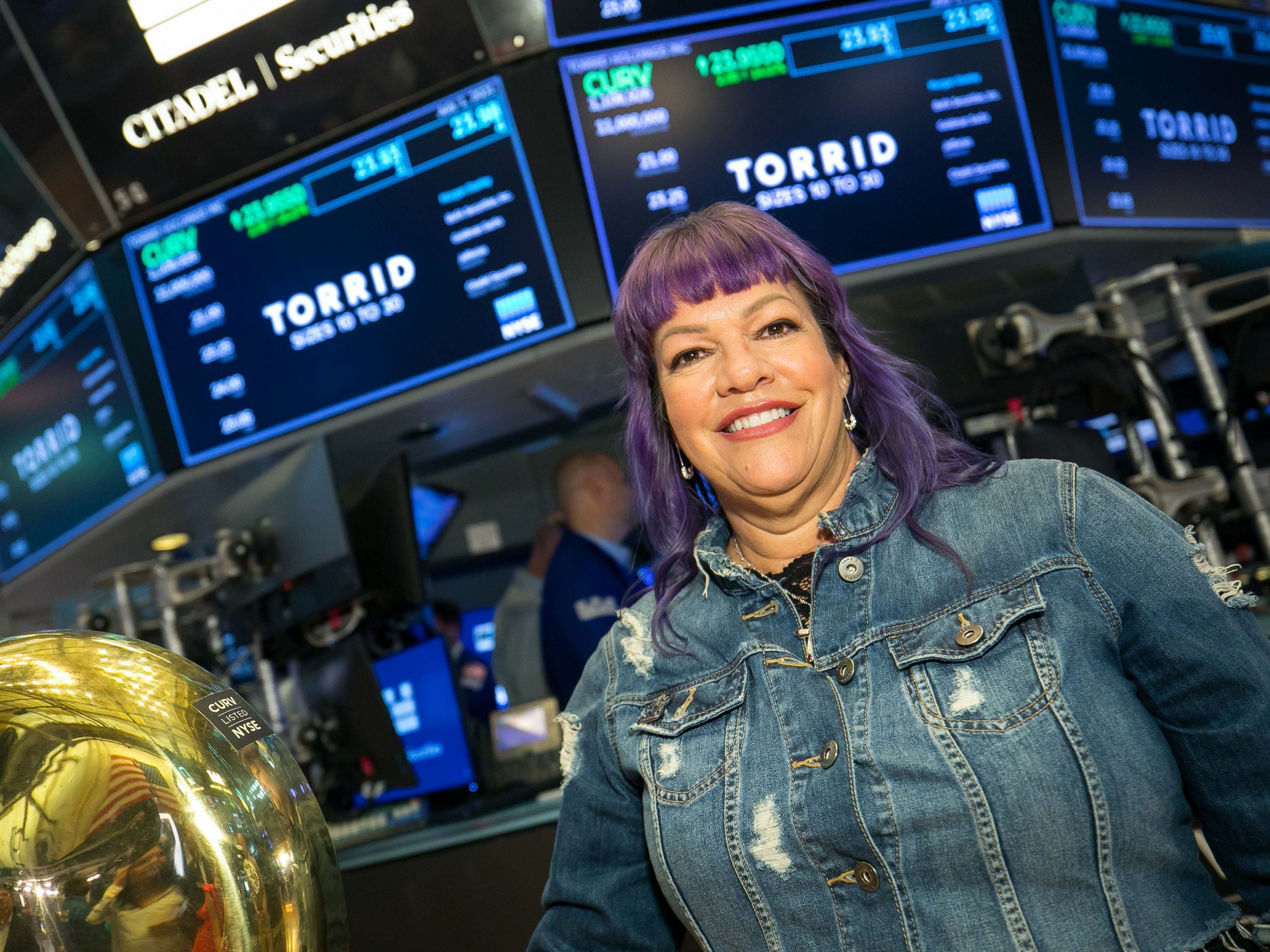 Torrid CEO Liz Muñoz at the New York Stock Exchange, celebrating the company's IPO.