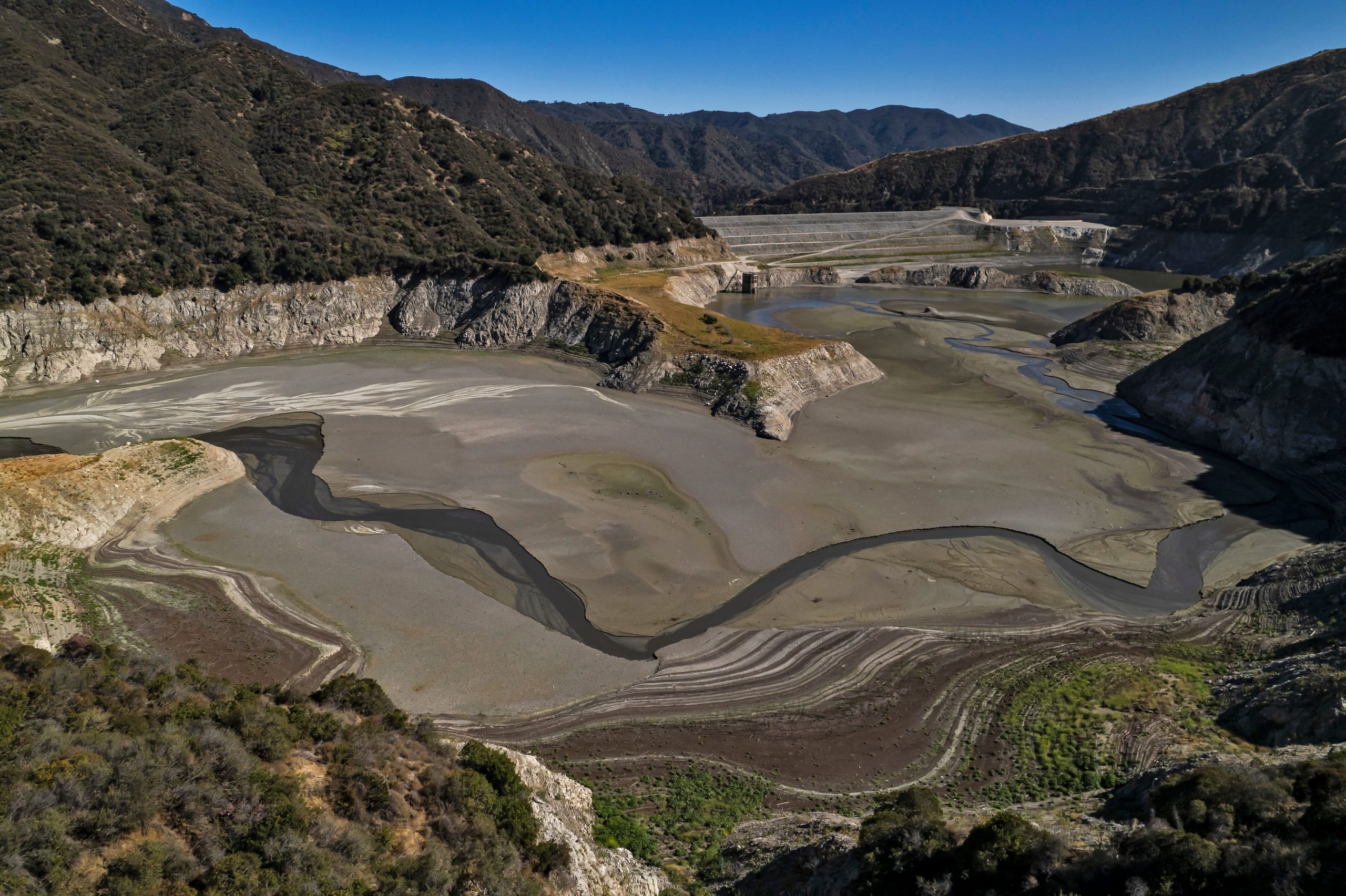 A wide aerial view of the reservoir dam area.