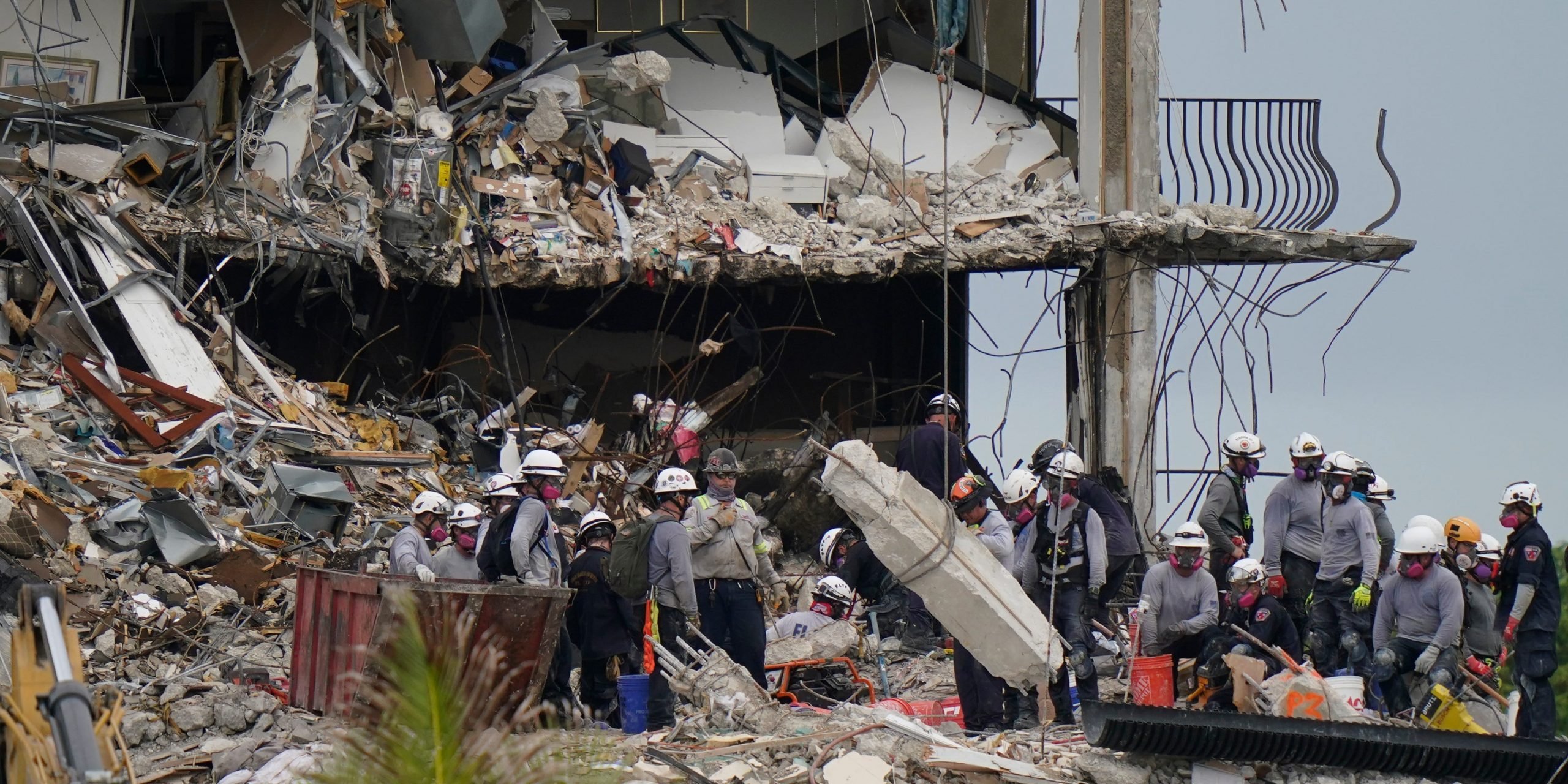 Search and rescue personnel work atop the rubble at the collapsed Champlain Towers South condo building.