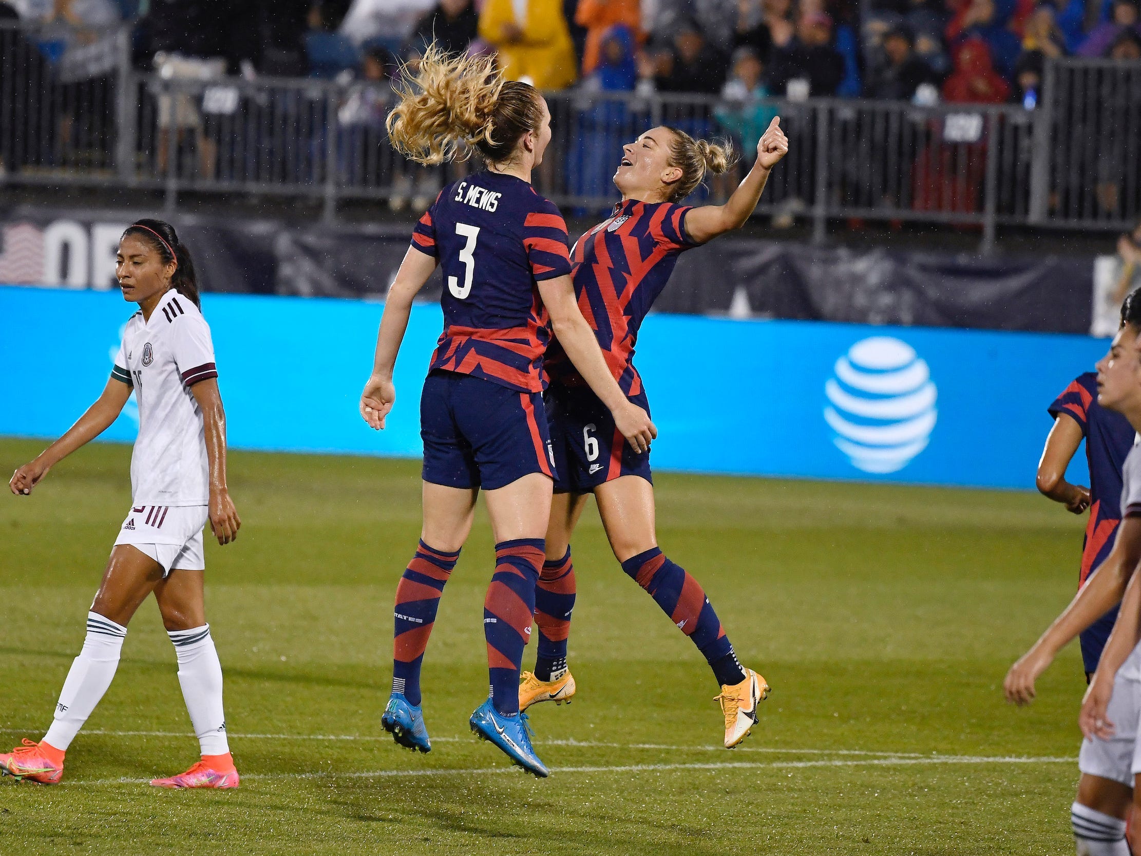 Sam Mewis and Kristie Mewis chest bump.