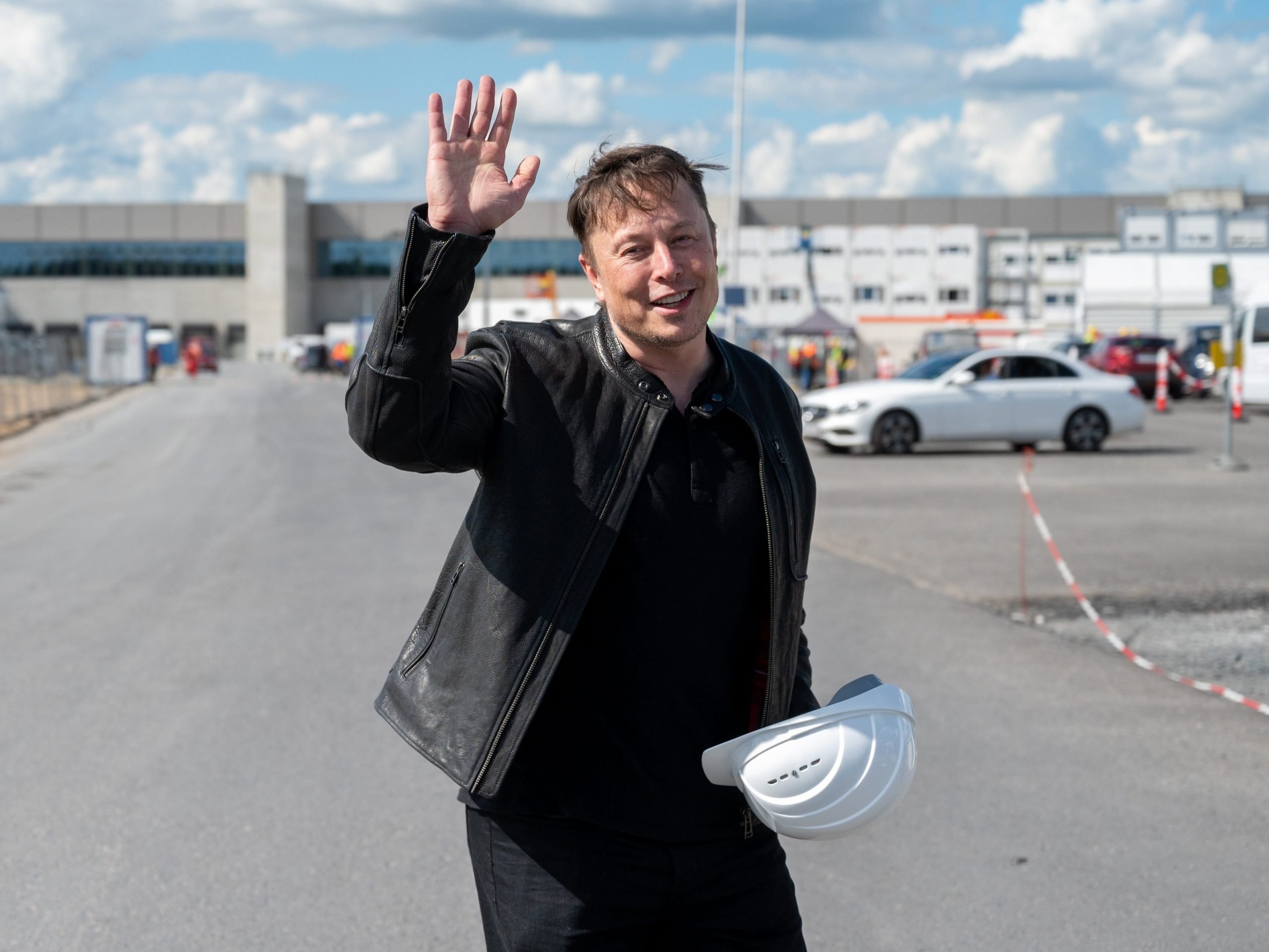 Elon Musk, Tesla CEO, stands on the construction site of the Tesla factory and waves, in Grünheide near Berlin, on  May 17, 2021.