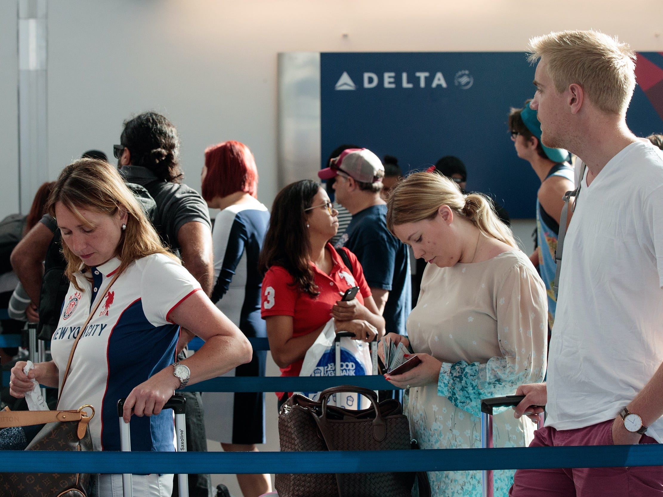Long airport lines at Delta Air Lines check-in.
