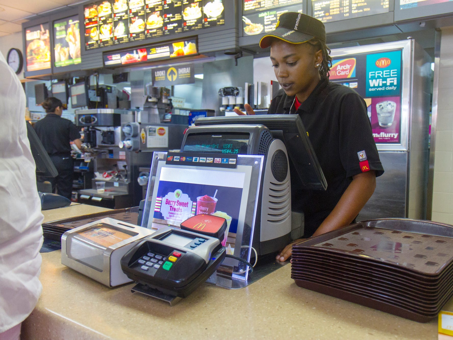 A cashier working behind the counter at McDonalds in Fort Pierce.