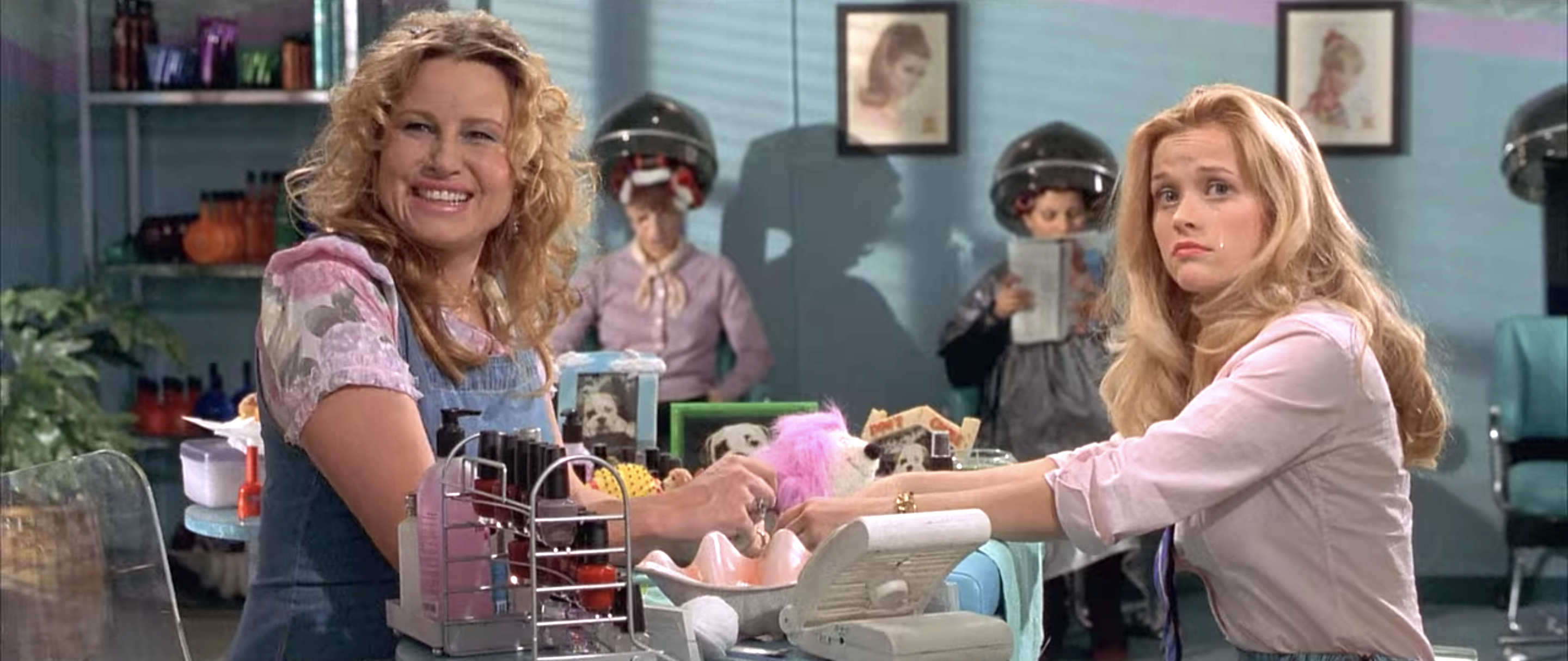 Jennifer Coolidge and Reese Witherspoon at a table at a nail salon in "Legally Blonde."