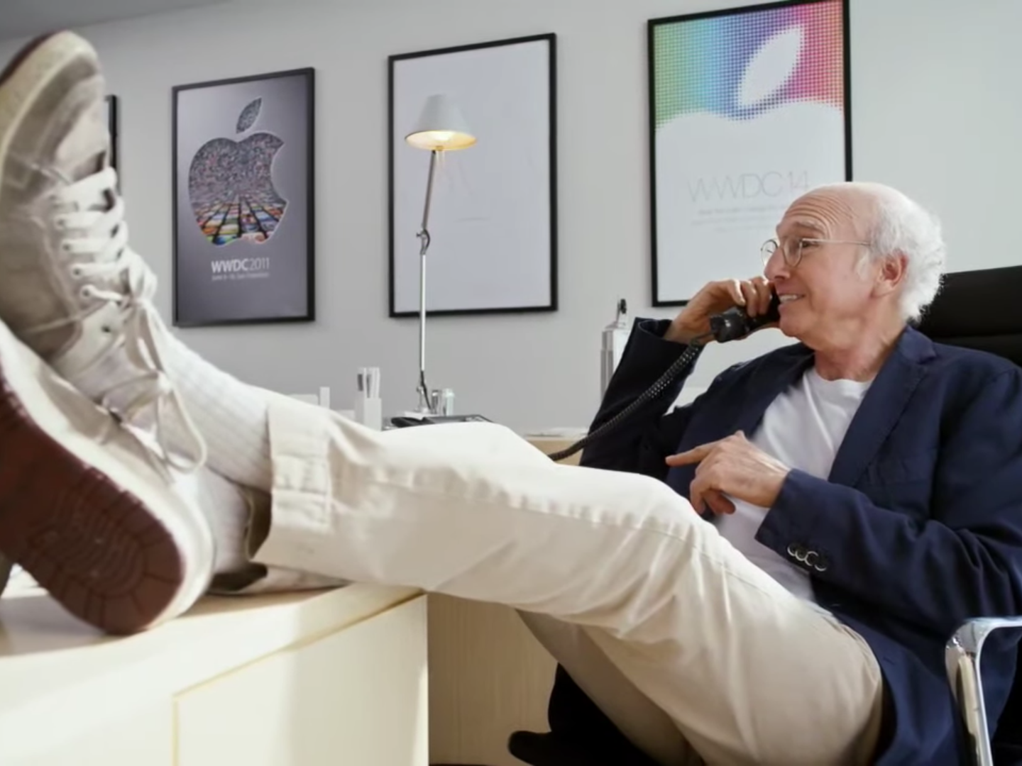 Larry David talks on phone with feet on desk at Apple headquarters