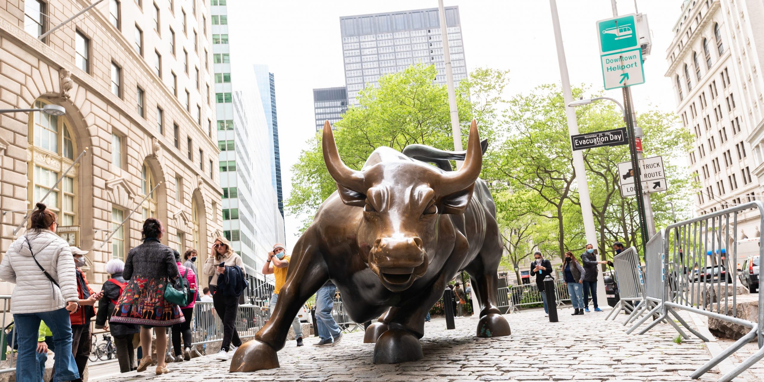 People visit the Charging Bull statue in New York City.