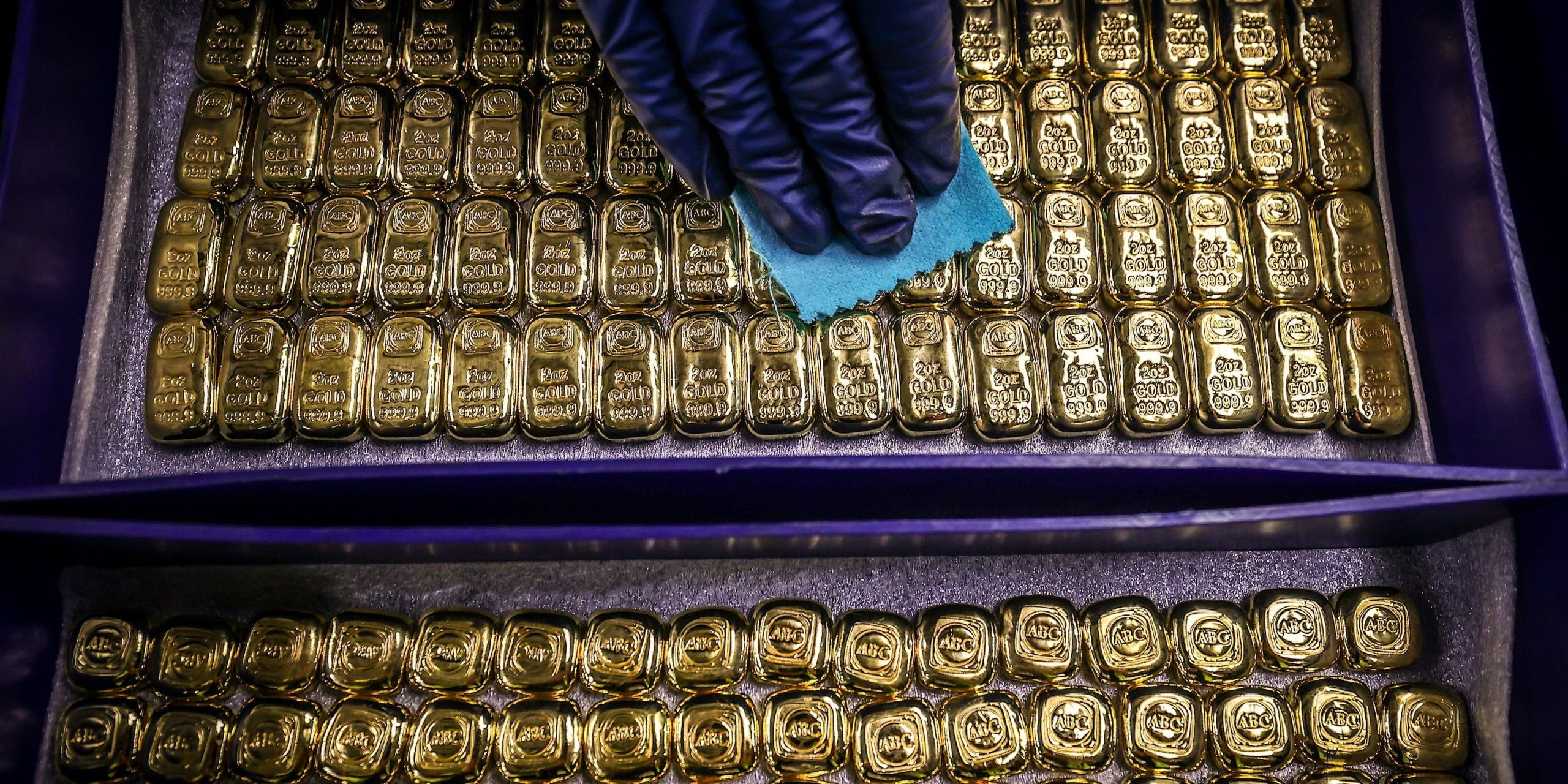 A worker polishes gold bullion bars at the ABC Refinery in Sydney on August 5, 2020. (Photo by DAVID GRAY/AFP via Getty Images)