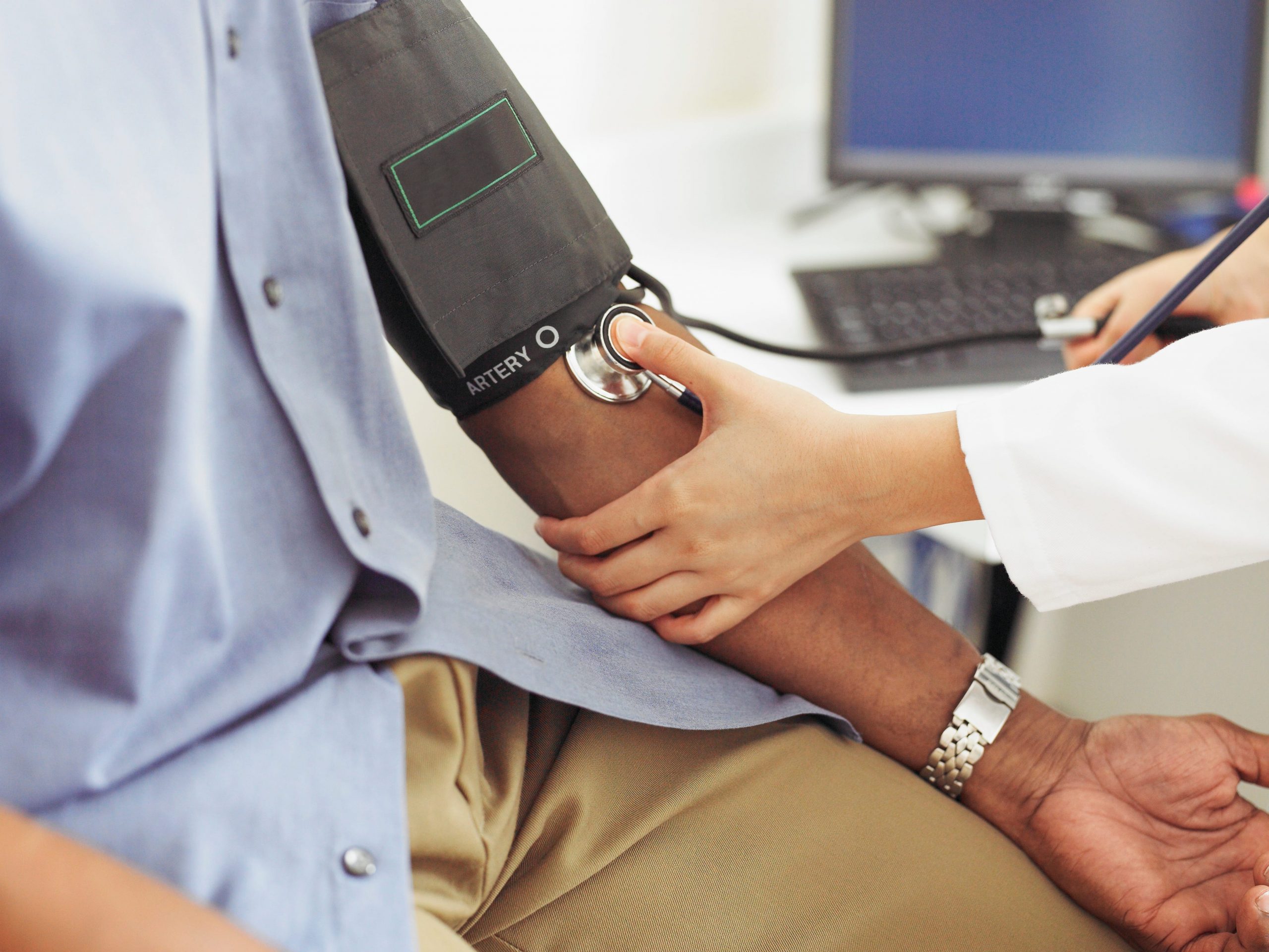 A medical professional taking high blood pressure