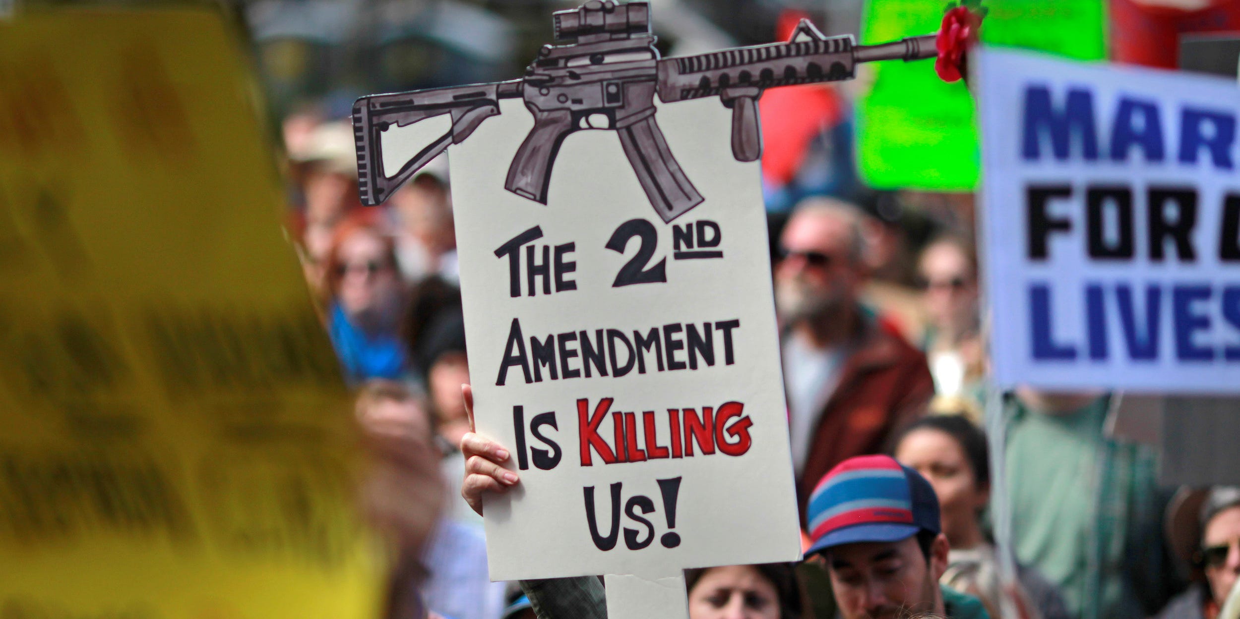 Protestors hold signs during a "March For Our Lives" demonstration demanding gun control in Sacramento, California, U.S. March 24, 2018.