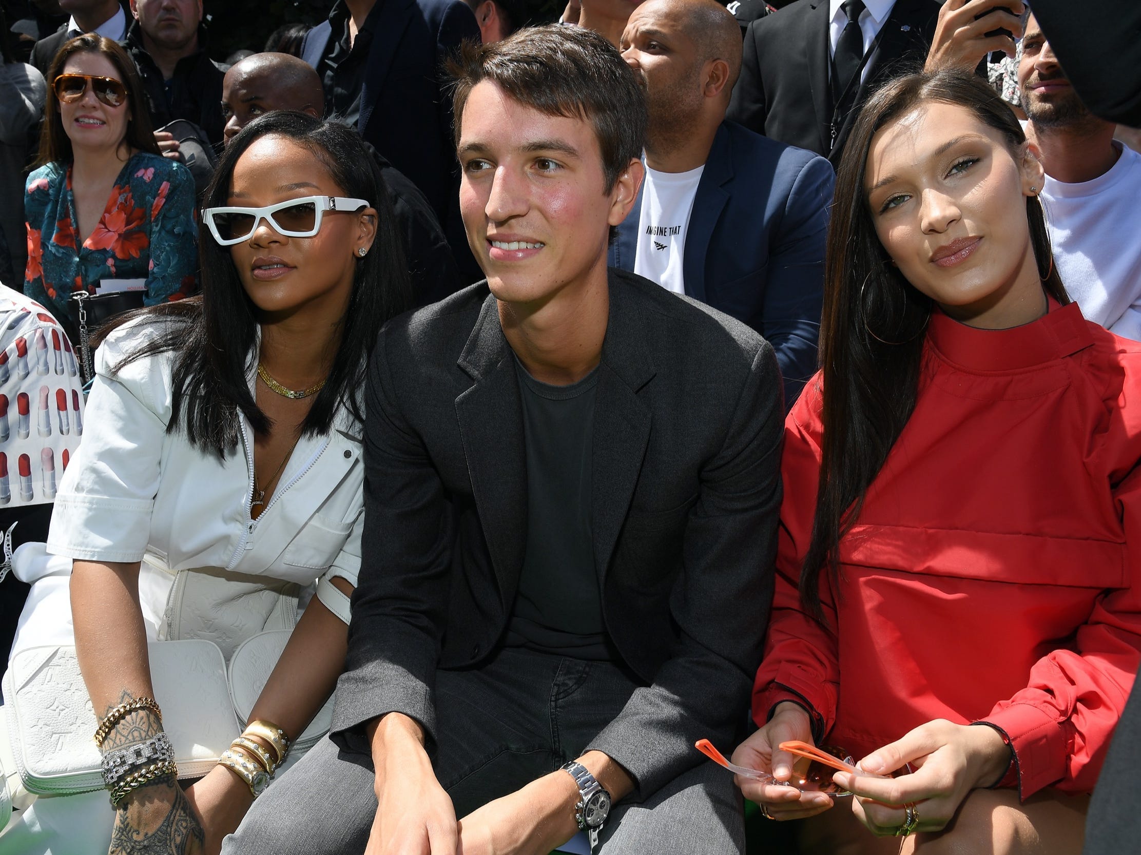 rihanna alexandre arnault and bella hadid sit in the front row of a fashion show in paris