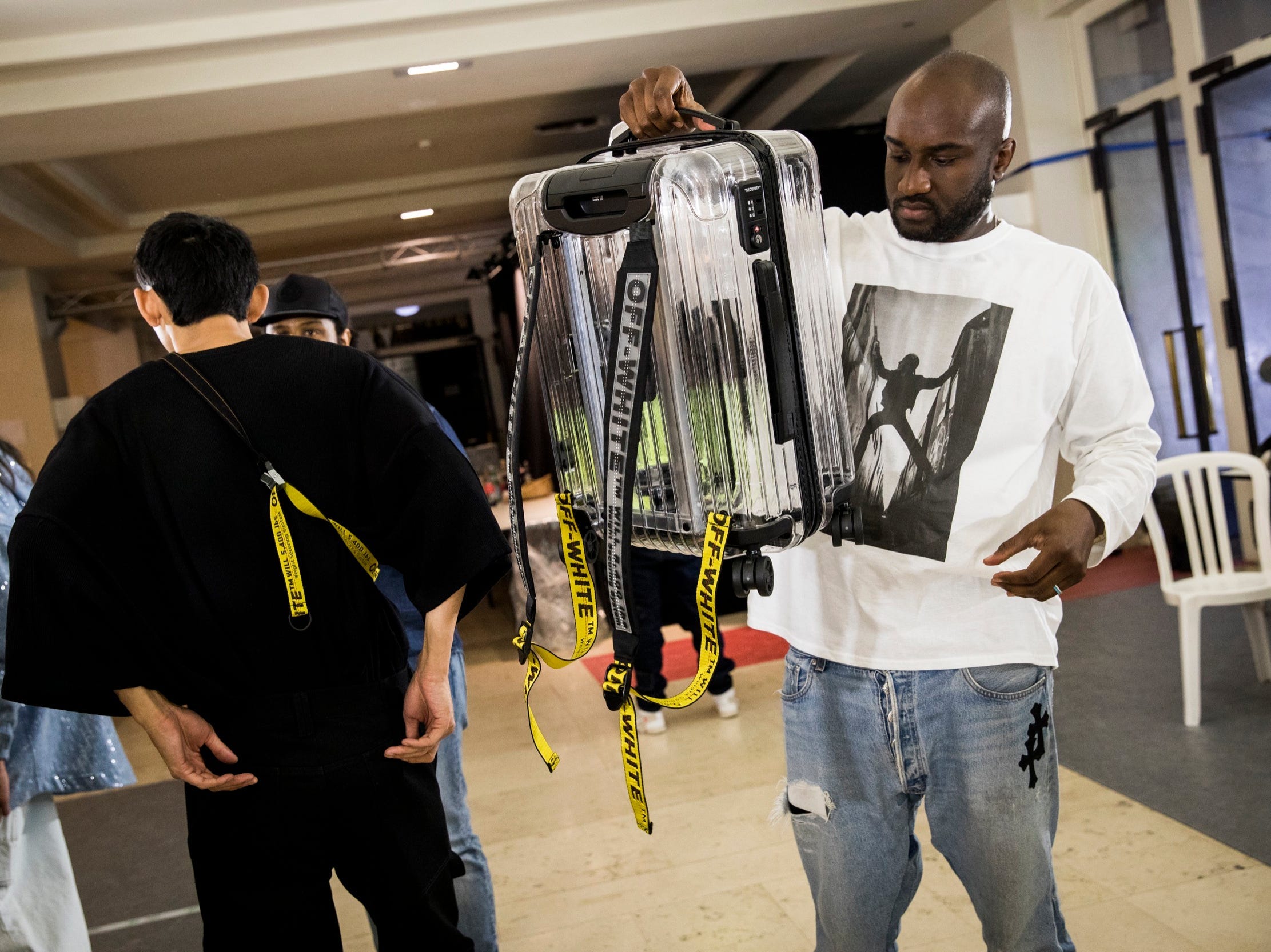 Virgil Abloh poses backstage with a Off-white/ / Rimowa Suitcase in Paris in June 2018