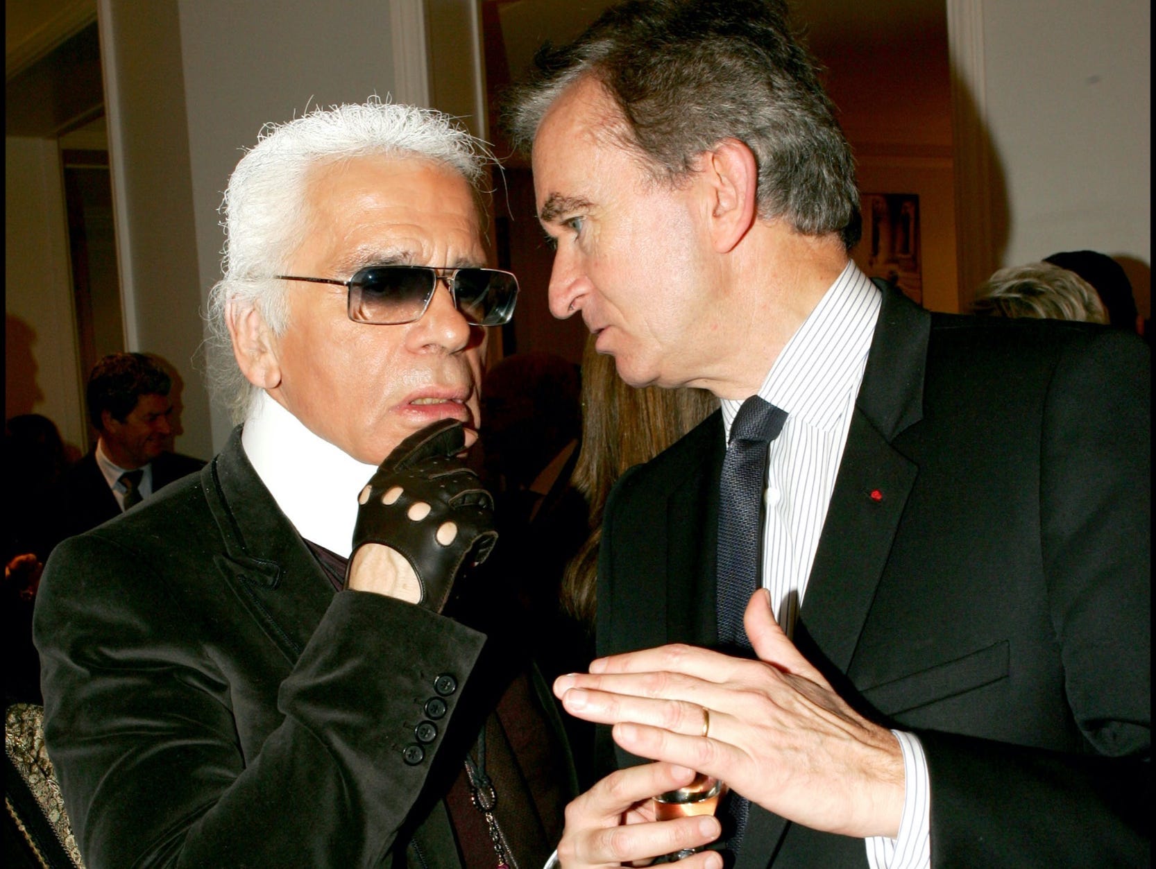 designer karl lagerfeld and bernard arnault speak at a fashion event in paris in 2005