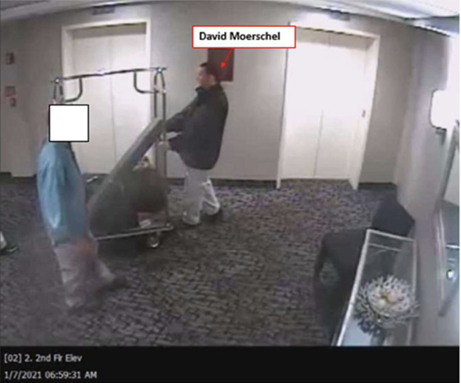 Surveillance footage showing Oath Keeper David Moerschel wheeling what appears to be a gun case in the Comfort Inn Ballston Hotel in Arlington, Virginia,