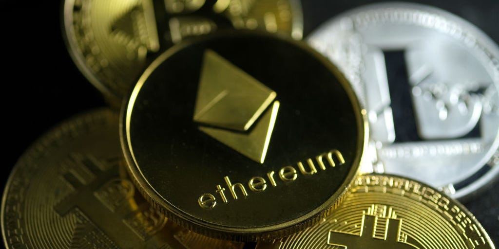Representations of digital cryptocurrencies, Ethereum, Bitcoin and Litecoin, are arranged