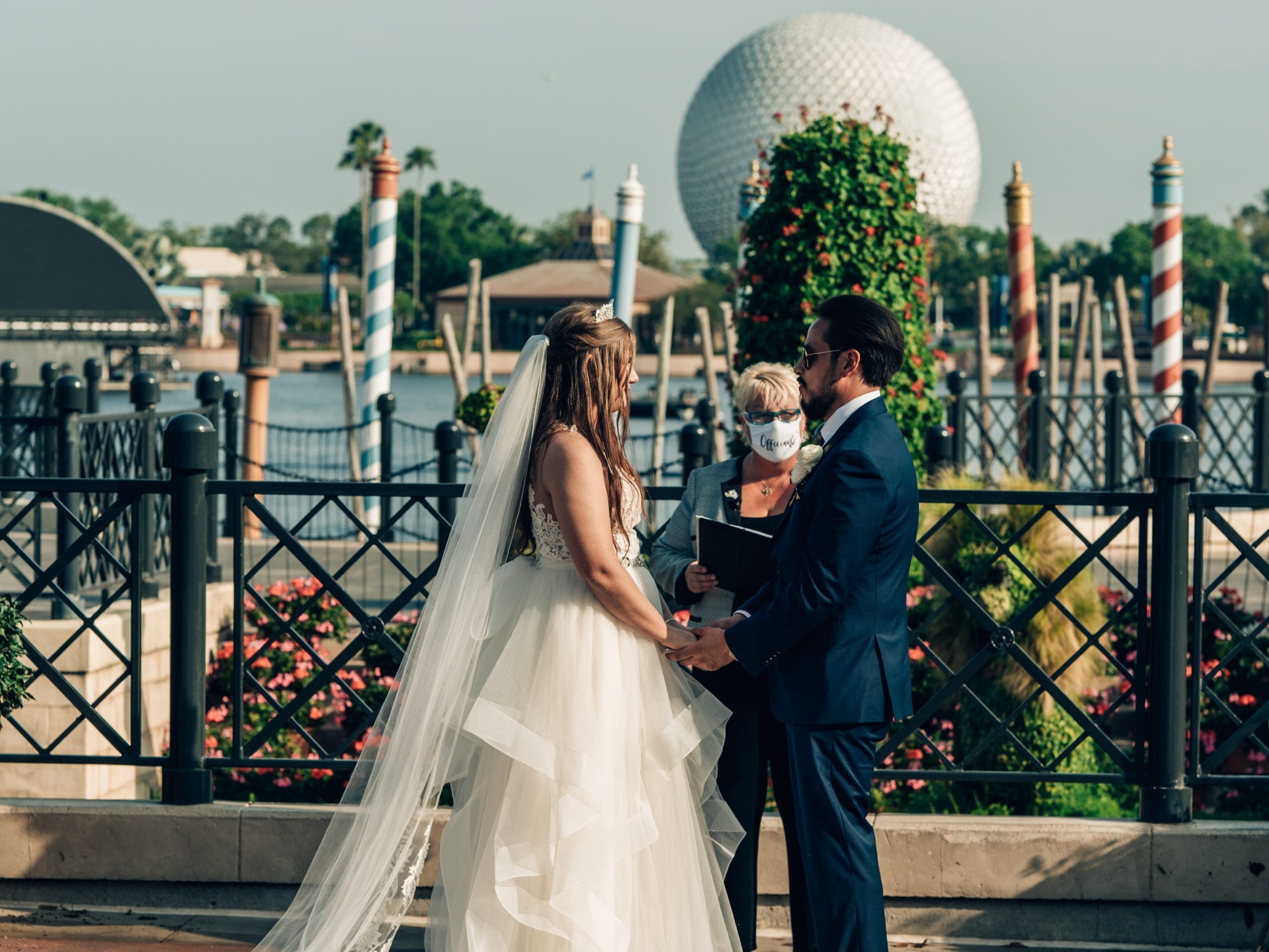 Couple getting married in front of Epcot ball at Italy Pavilion