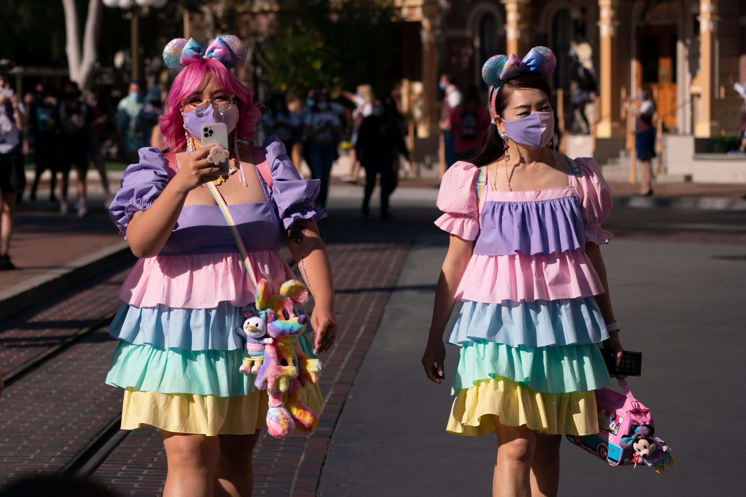 Guests walk along the Main Street USA at Disneyland in Anaheim, Calif., Friday, April 30, 2021.