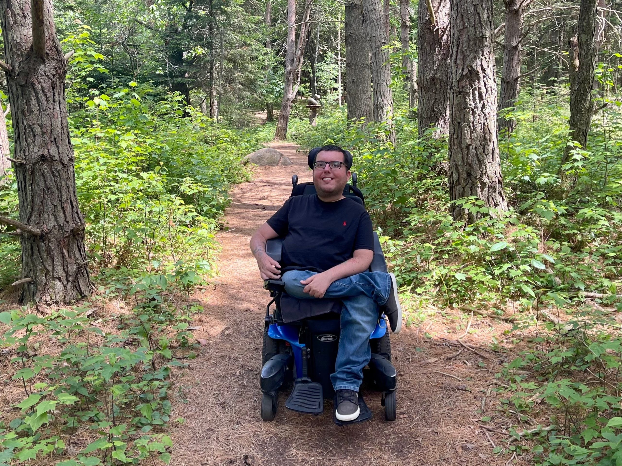 Cory Lee, a wheelchair user, on a nature trail in the Adirondacks.