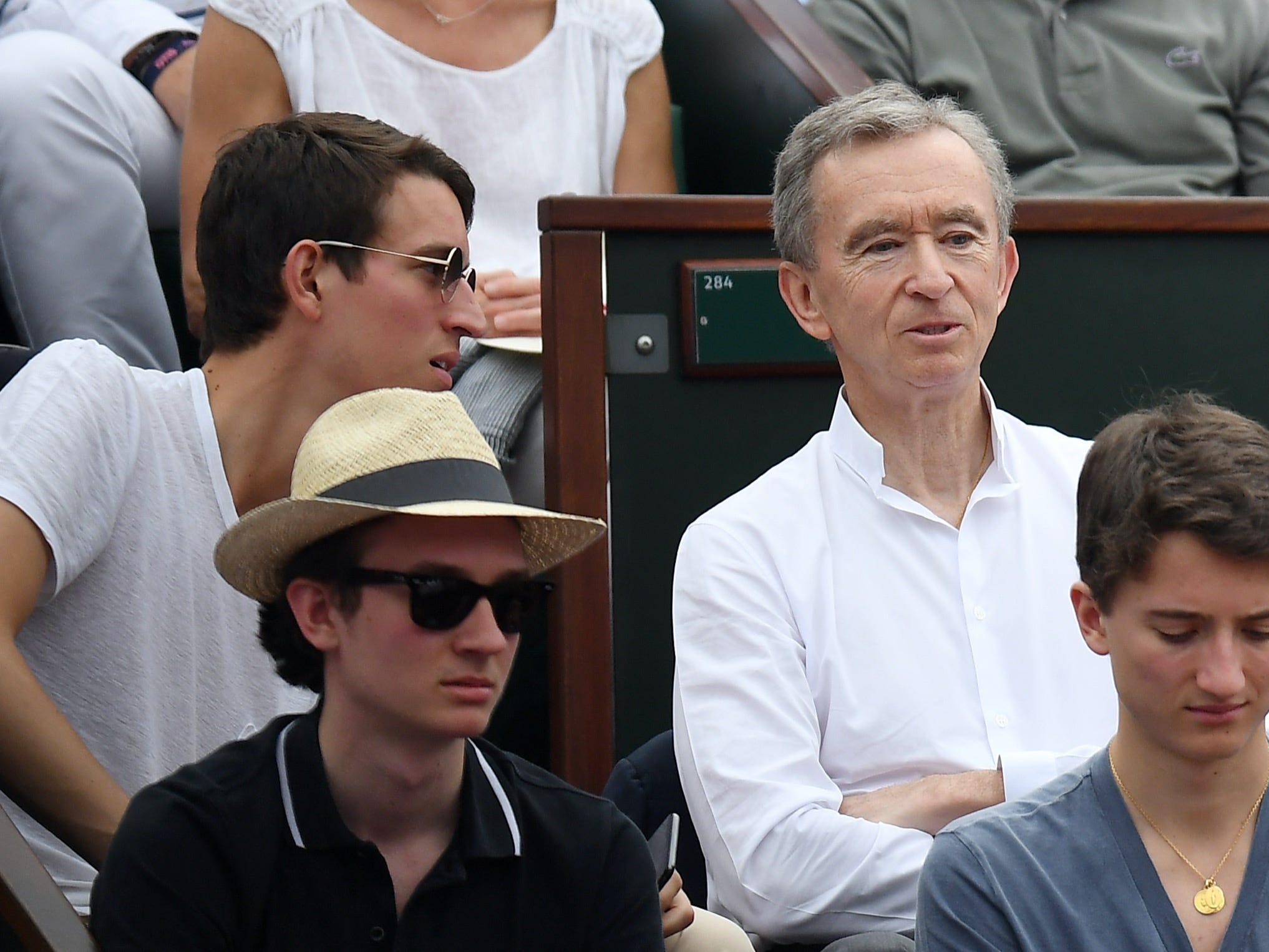 bernard, alexandre, frederic, and jean arnault watch tennis match at french open