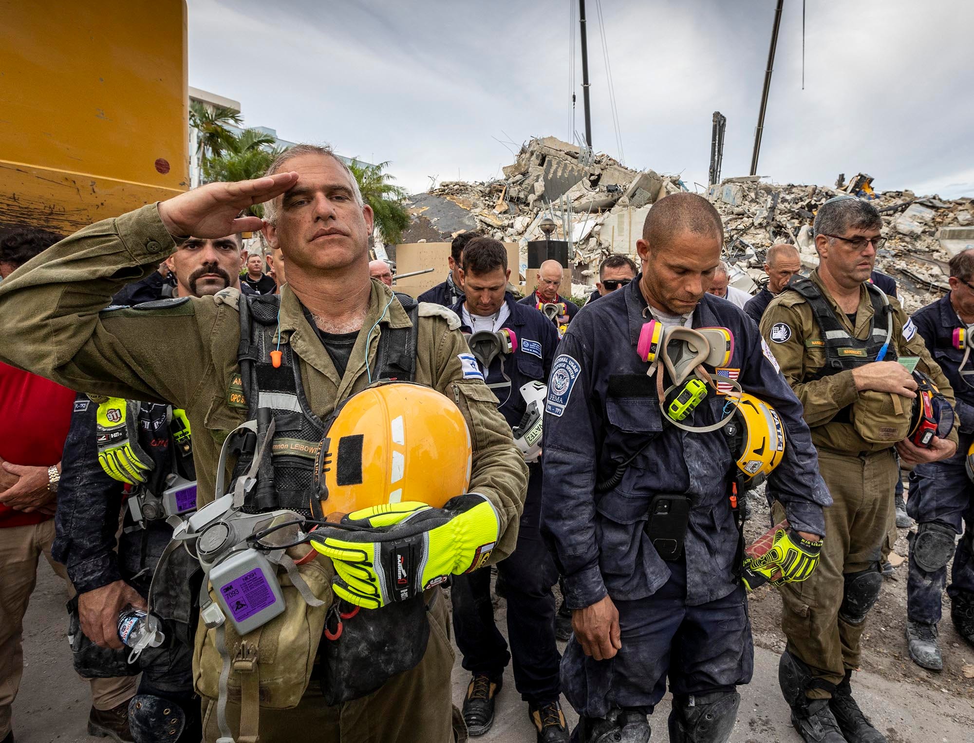 Search-and-rescue team members gathering for a moment of silence in Surfside, Florida.