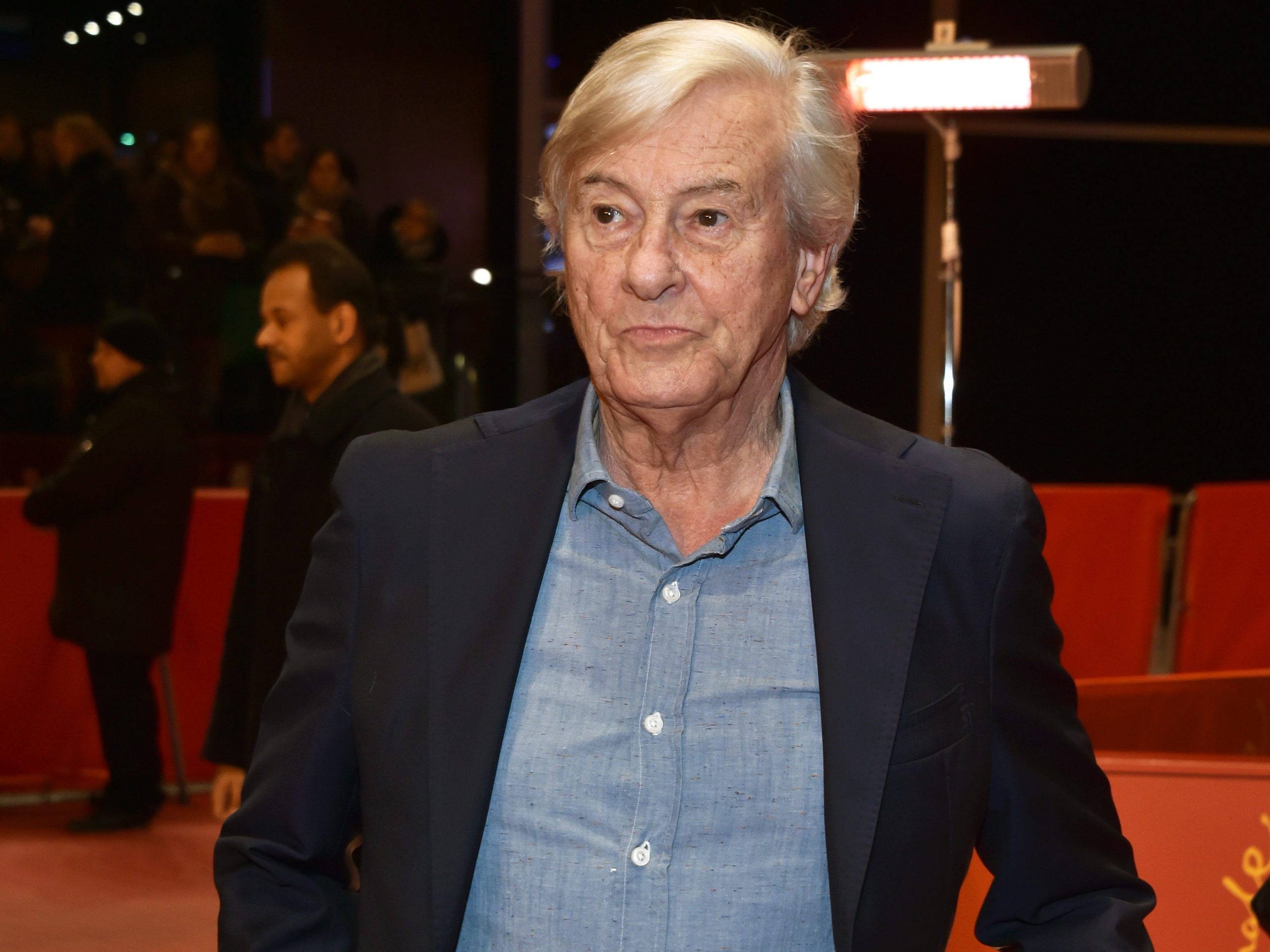 Paul Verhoeven in a suit and blue shirt