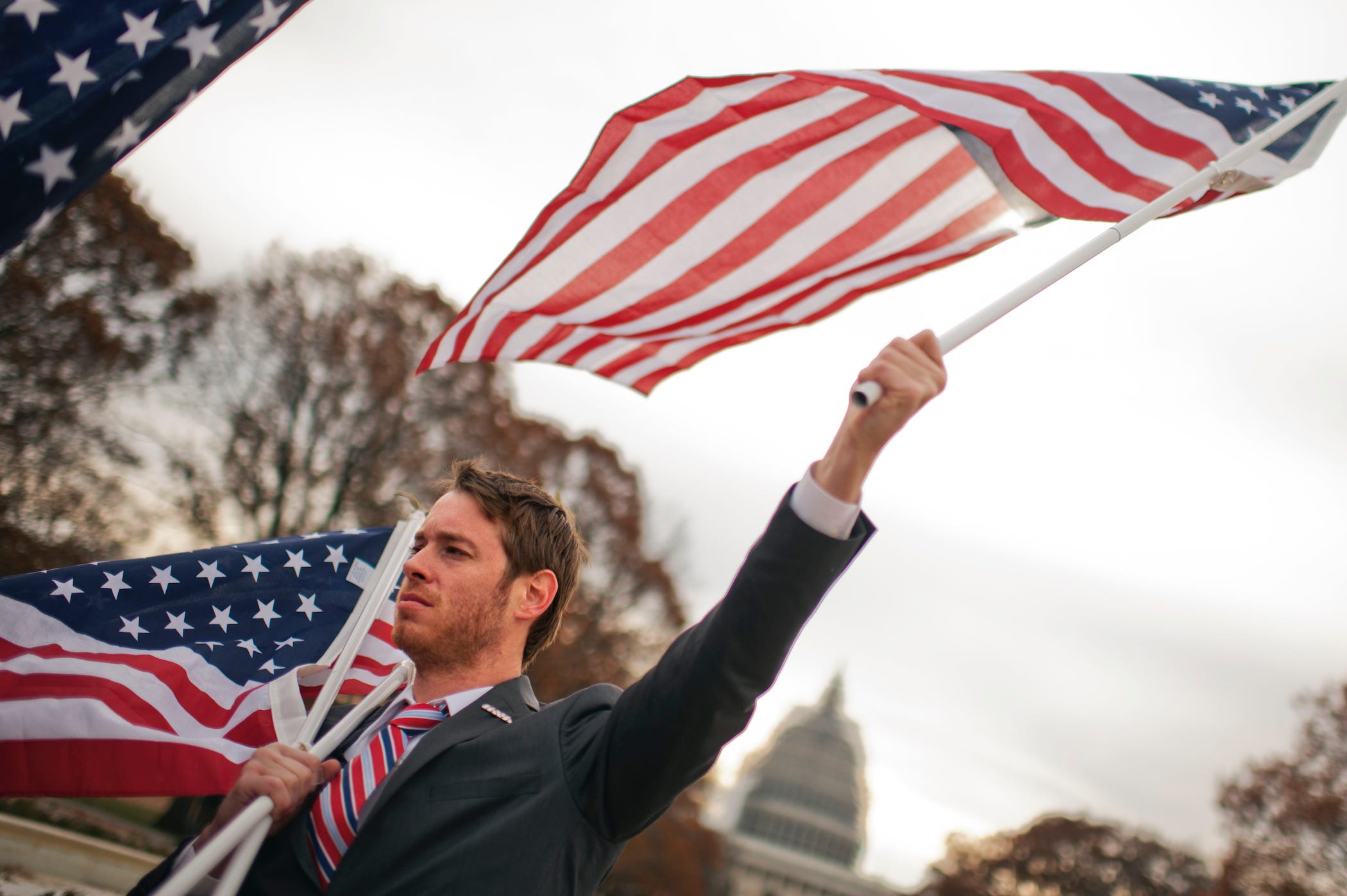 a marine veteran holding flags, parading through washington